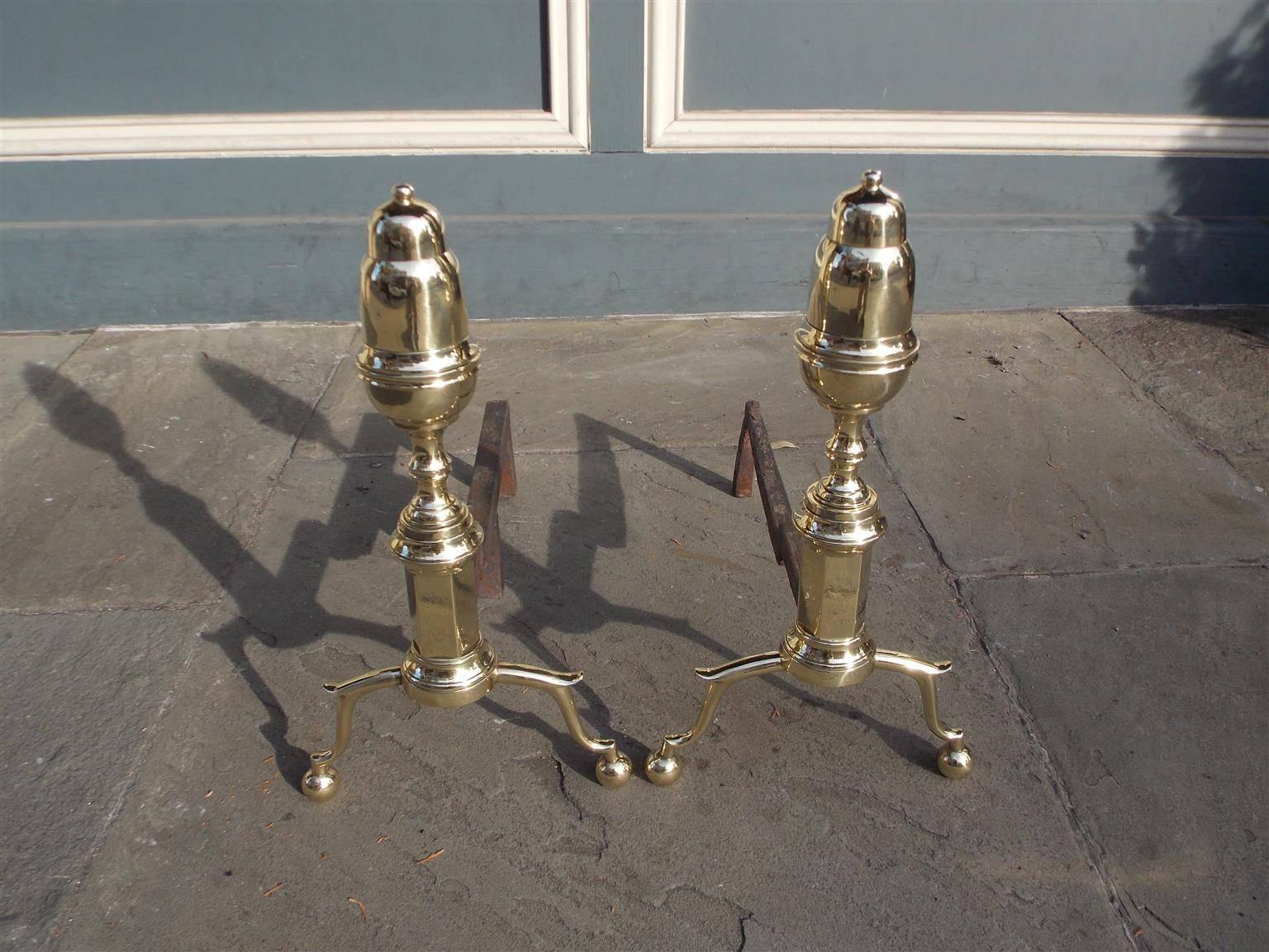 Pair of American brass elongated acorn top andirons with rare extra ball finials, turned ringed faceted plinths, and terminating on spur legs with ball feet,
New York, Early 19th century.