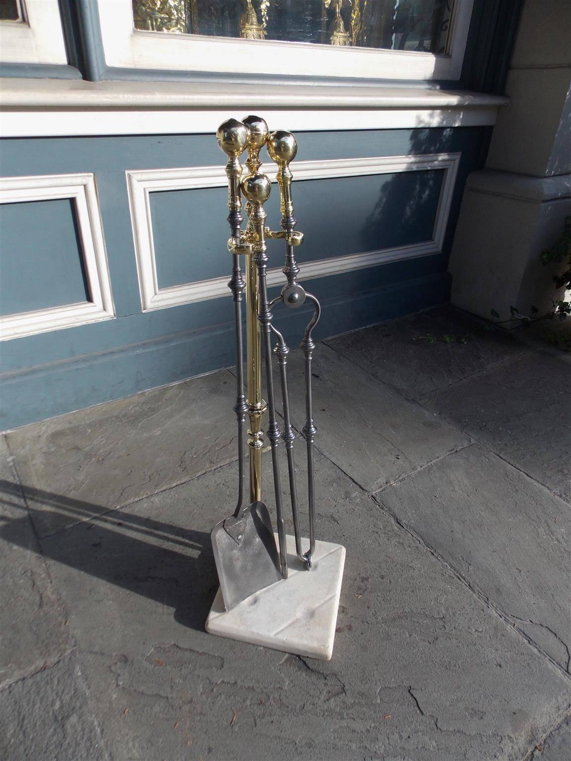 Set of American Colonial brass and polished steel fire tools with bulbous brass ball handles, a brass jamb hook and shaft, and terminating on marble squared base with round depressions and straight gouges. Set consist of shovel, tong and poker,