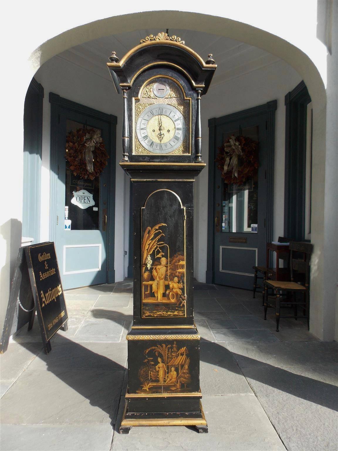 Swedish black lacquered and gilt Chinoiserie tall case clock with arched decorative floral hood, flanking finials, turned bulbous columns, ormolu and steel engraved face, figural floral stenciled trunk, gilt carved molded edge, and terminating on a