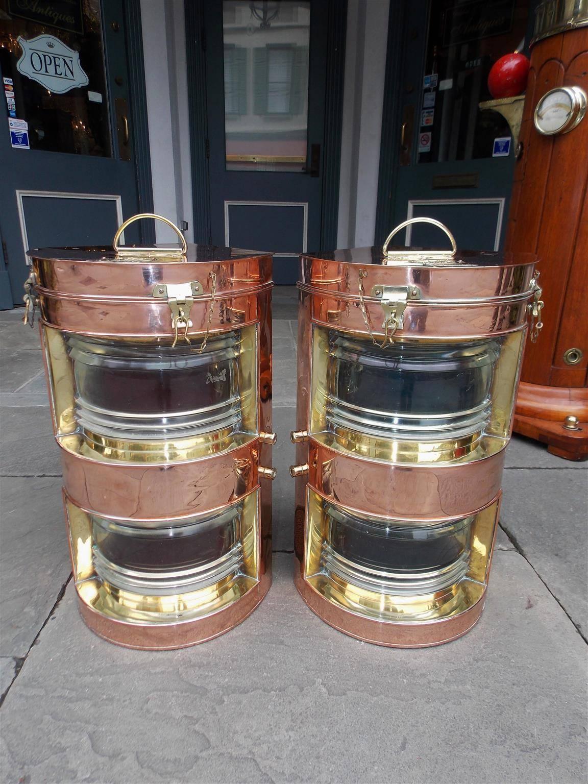 Pair of copper and brass Tung Woo double stacked port and starboard ship lanterns each with a single handle, hinged top, mounting brackets, and the original Fresnel lenses. Stamped badges on exterior top, Early 20th Century. Pair were original gas