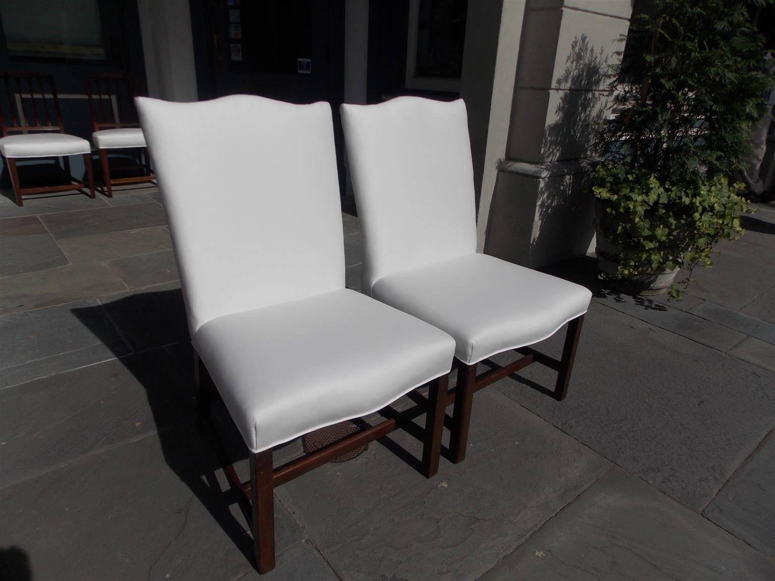 Pair of English mahogany serpentine back lolling chairs with squared tampered splayed legs and connecting stretchers. Chairs are upholstered in white muslin, Late 18th Century.