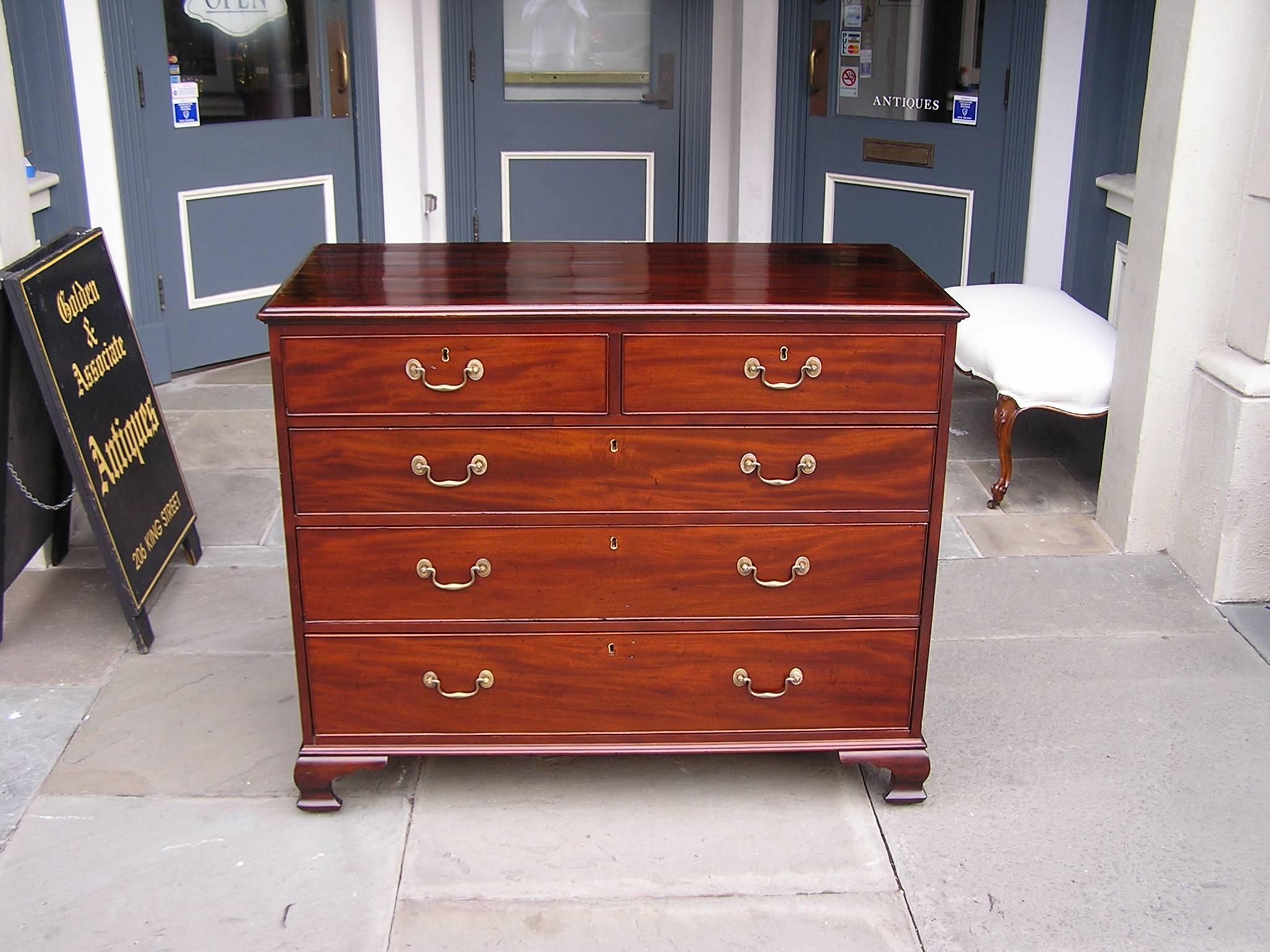 English Chippendale mahogany graduated five drawer chest with a carved upper molded edge, original brass pulls & escutcheons, terminating on the original bracket feet,  Late 18th Century.