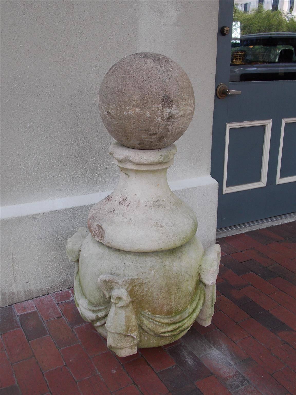 Italian marble architectural cornice finial with circular ball top, ringed urn plinth, resting on a bulbous base with a ribbon and swag motif. Piece was one of the original architectural cornice finials displayed on The Exchange building @ the