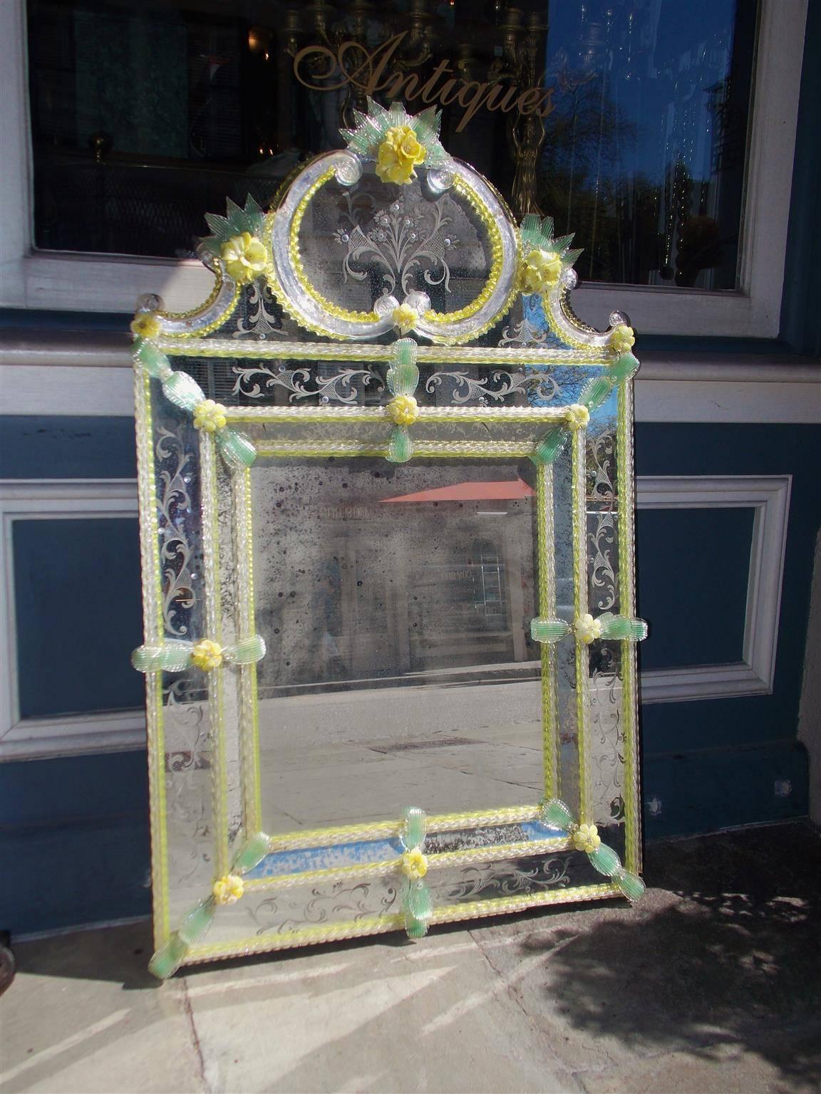 Venetian Murano wall mirror with vibrant foliage borders, acid etched scrolled acanthus flower baskets, and twisted surrounding glass rods throughout piece. Mirror retains the original glass and wood backing, Late 19th Century.