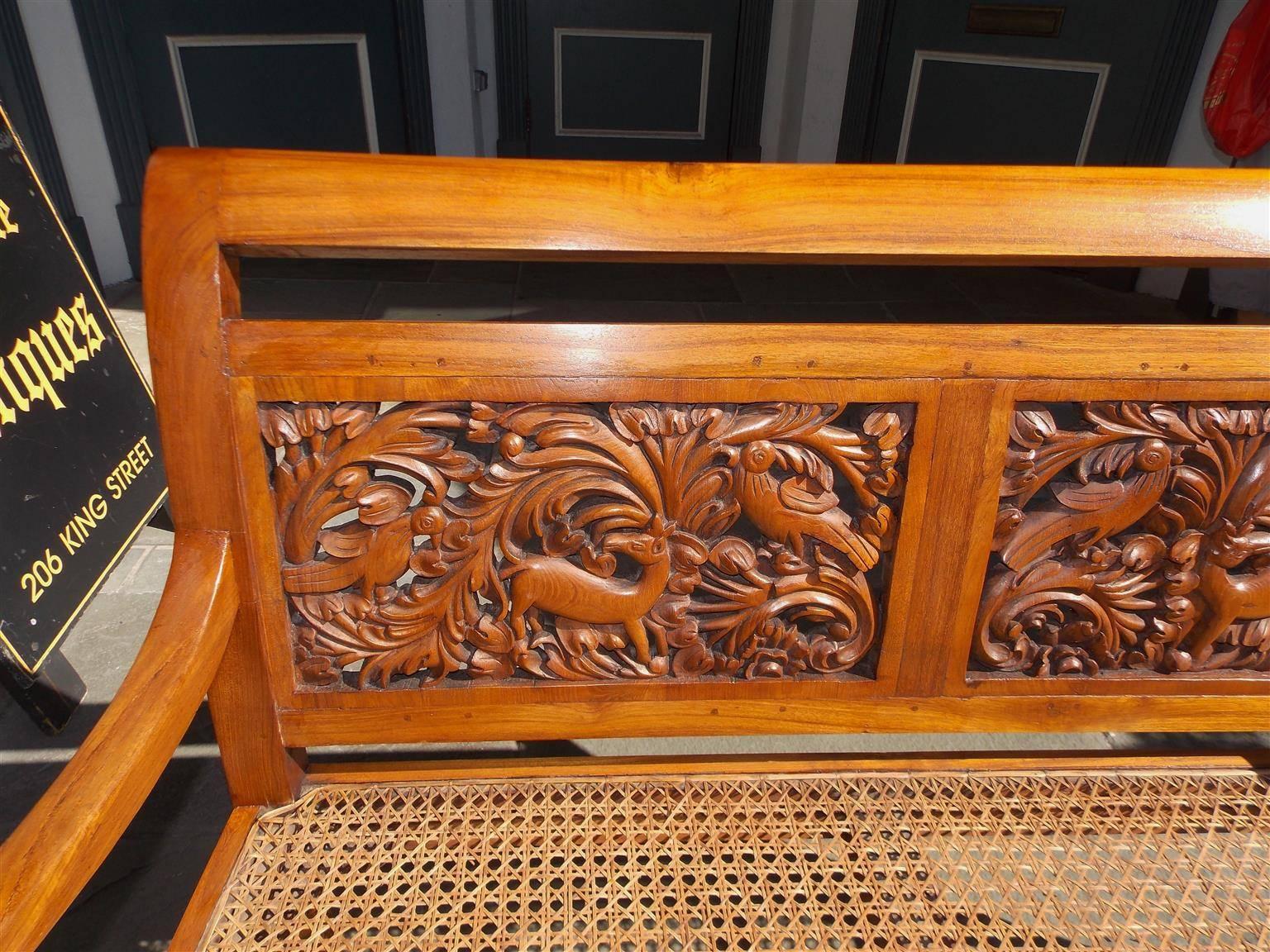 Hand-Carved Caribbean Kings Wood Carved Foliage and Animal Cane Settee, Circa 1830