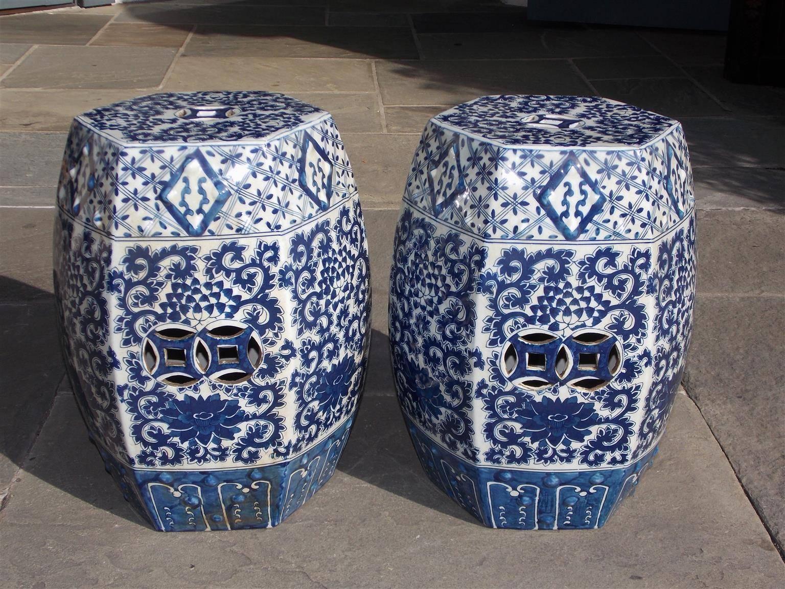 Pair of Chinese porcelain glazed hexagon garden benches with vibrant floral colors, circular decorative cutouts, diamond motif, and resting on a cobalt border at base, 20th Century
Benches are 11