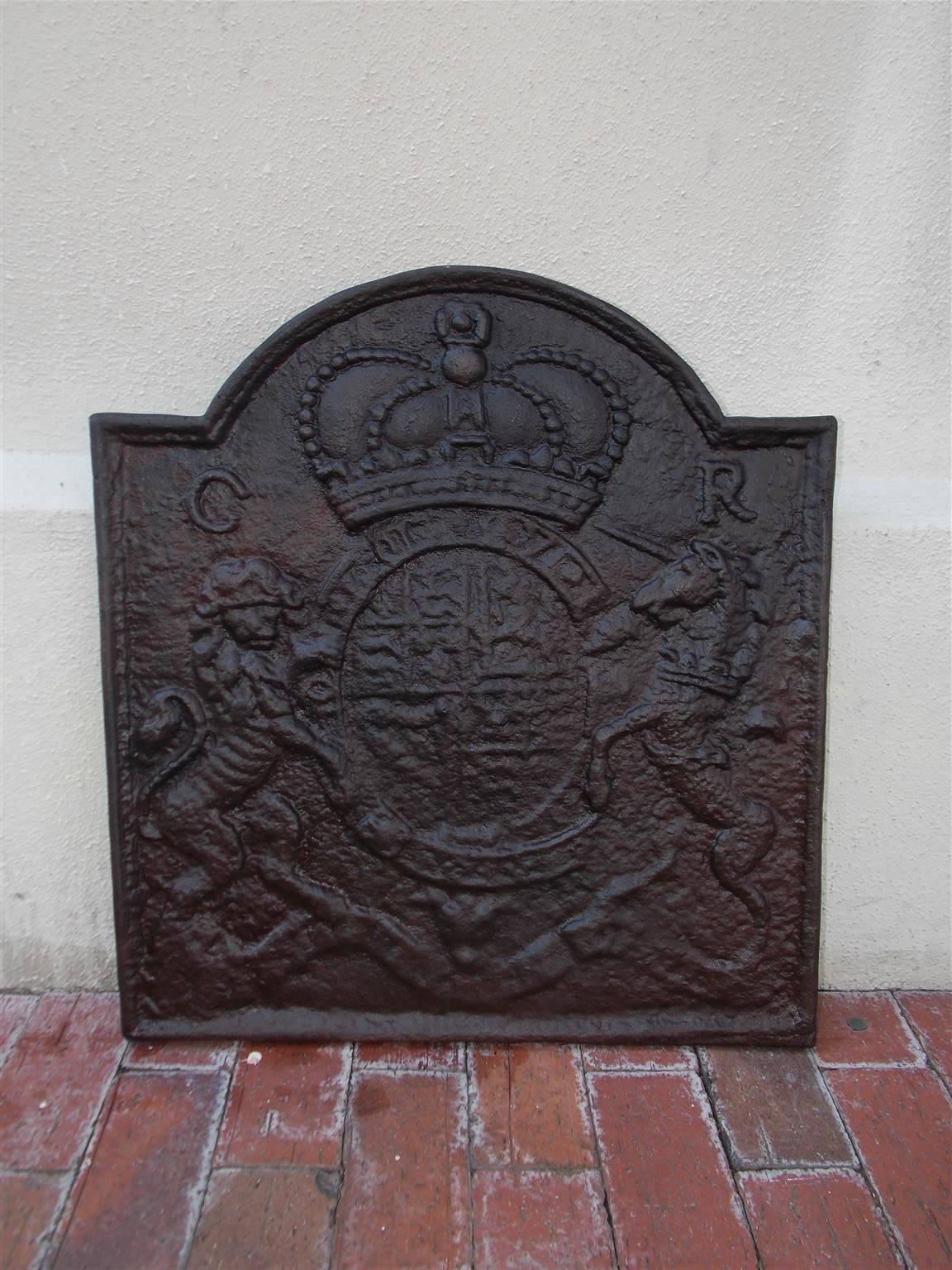 English cast iron fireback with a centered royal coat of arms flanked by a lion and unicorn with lower ribbon motif. Casting by Thomas Elsley. Thomas Elsley was a prolific cast iron artist that exported many fire backs in his career, Early 19th