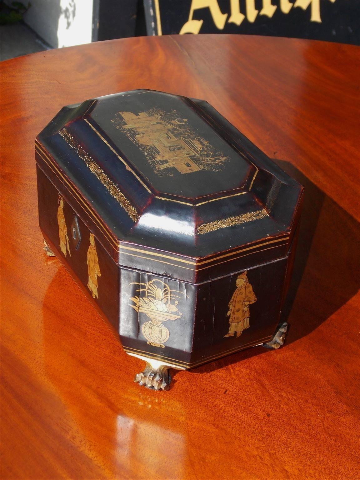English Japanned black lacquered tea caddy with gilt figural landscape scenes, removable interior chased decorative pewter tea bins,  original ivory knobs , lids, and terminating on gilt lions paw feet,  All Original , Early 19th century.