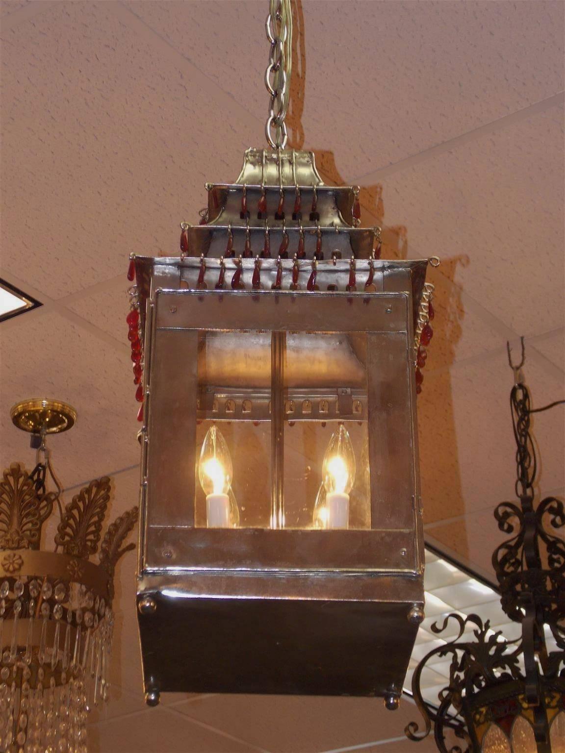 French tin hand-painted silver pagoda hanging lantern with upper tiered ruby pear-shaped prisms and interior four-light cluster. Originally candle powered and has been electrified, Mid-19th century.