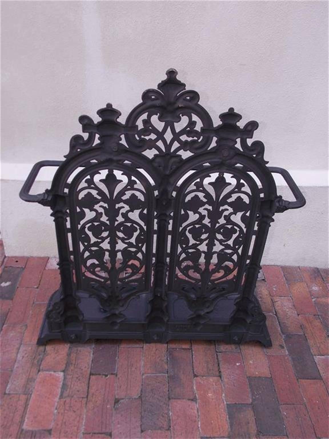 Scottish cast iron umbrella stand with decorative urns, swags, and floral motif resting on a molded edge rectangular base with two removable pans for water . Mid-19th century. Carron Company was the first large-scale cast iron smelting company in