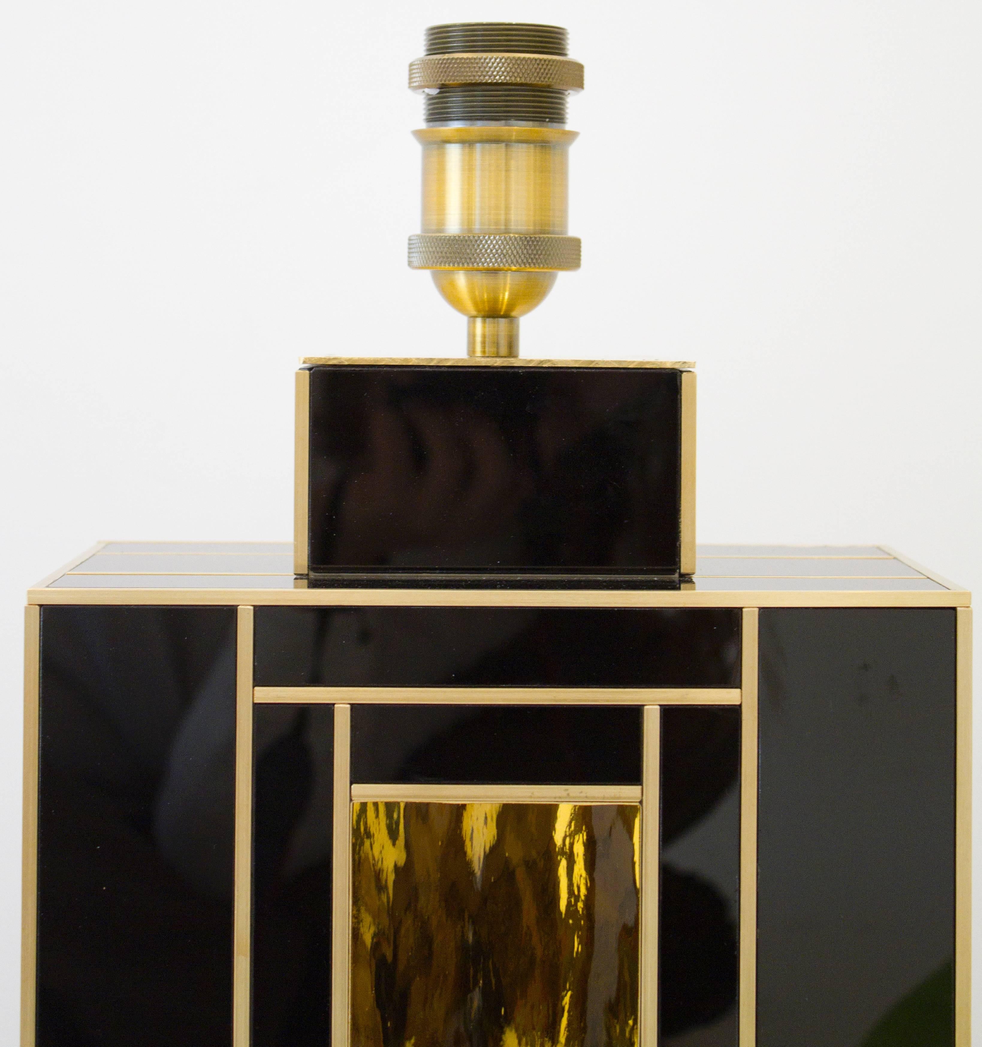 One of a kind pair of rectangular black art glass lamps with textured square gold glass inserts in center. Each glass element is separated and set out by solid brass inlays. Solid and heavy. Handcrafted in Spain and signed by artist/maker.