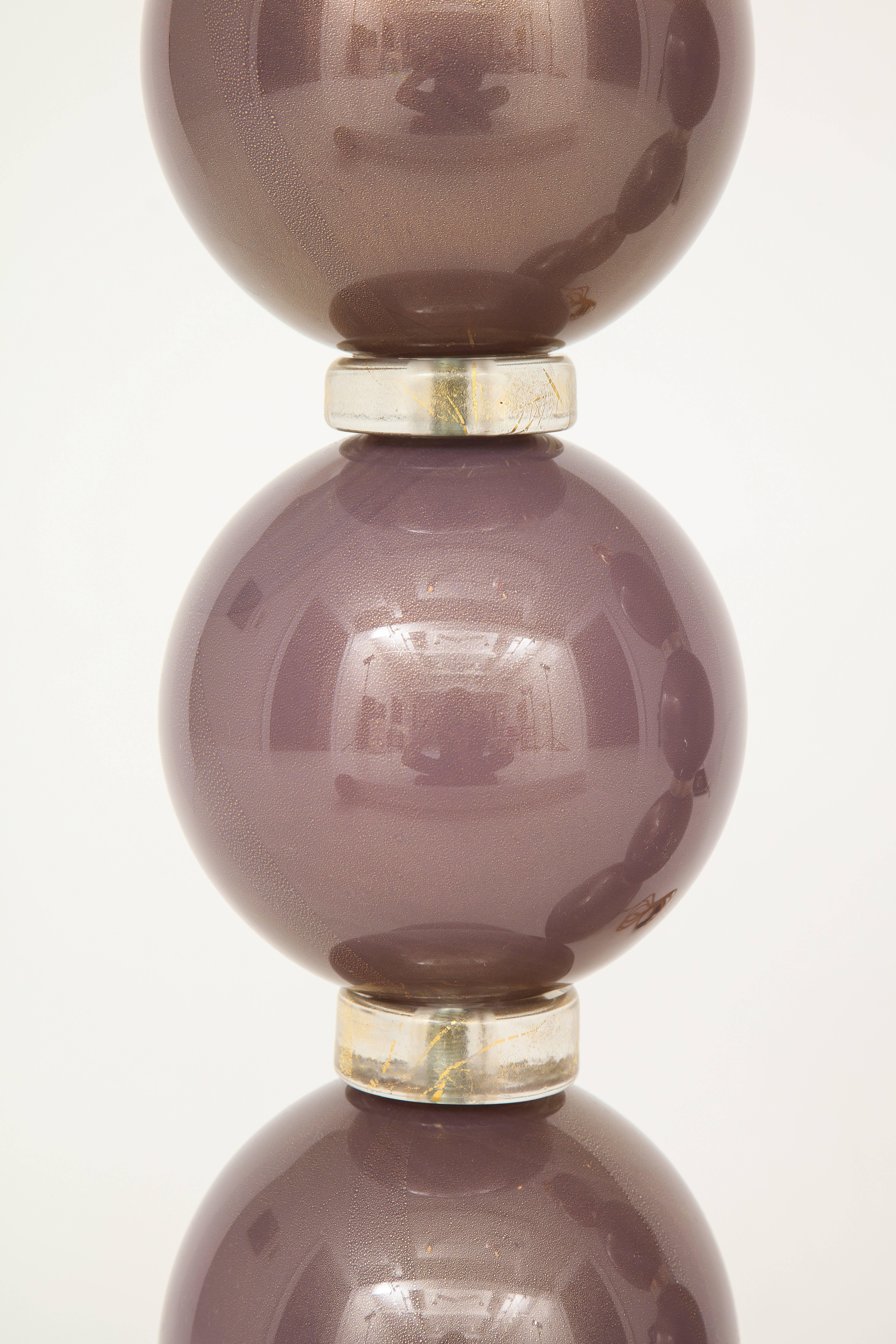 Stunning pair of handblown sphere lamps with rings. The “incamisciato” layered purple or amethyst spheres are separated by clear glass rings infused with 23-carat gold. Signed by the Glass Master himself. The height below includes light socket. This
