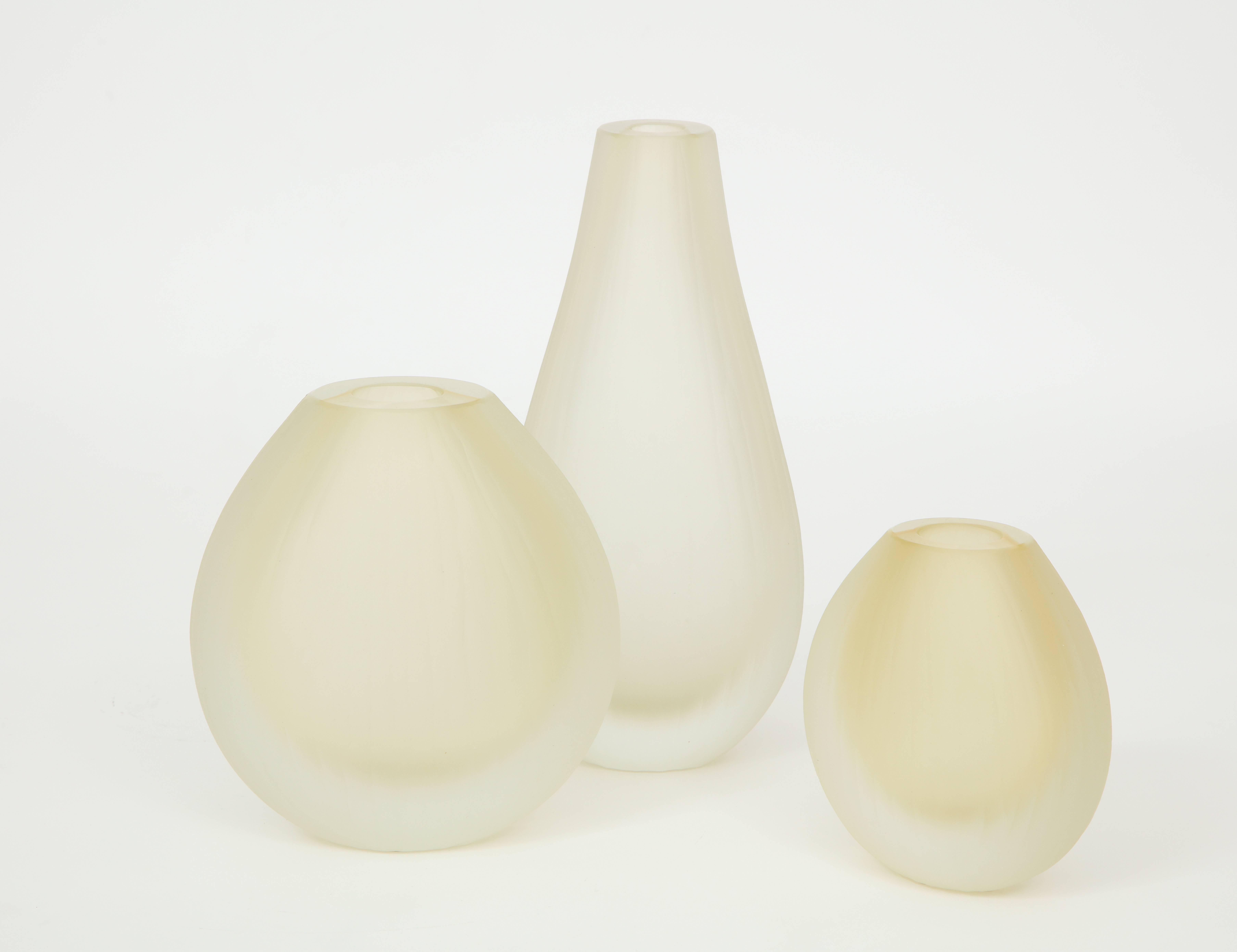 Set of three handblown oval Murano glass vases. Glass is softly ridged and frosted to give it that "iced" look. The color is absolutely stunning varying in shades of yellow/citrine. Signed by the Murano glass master himself. Vases vary in