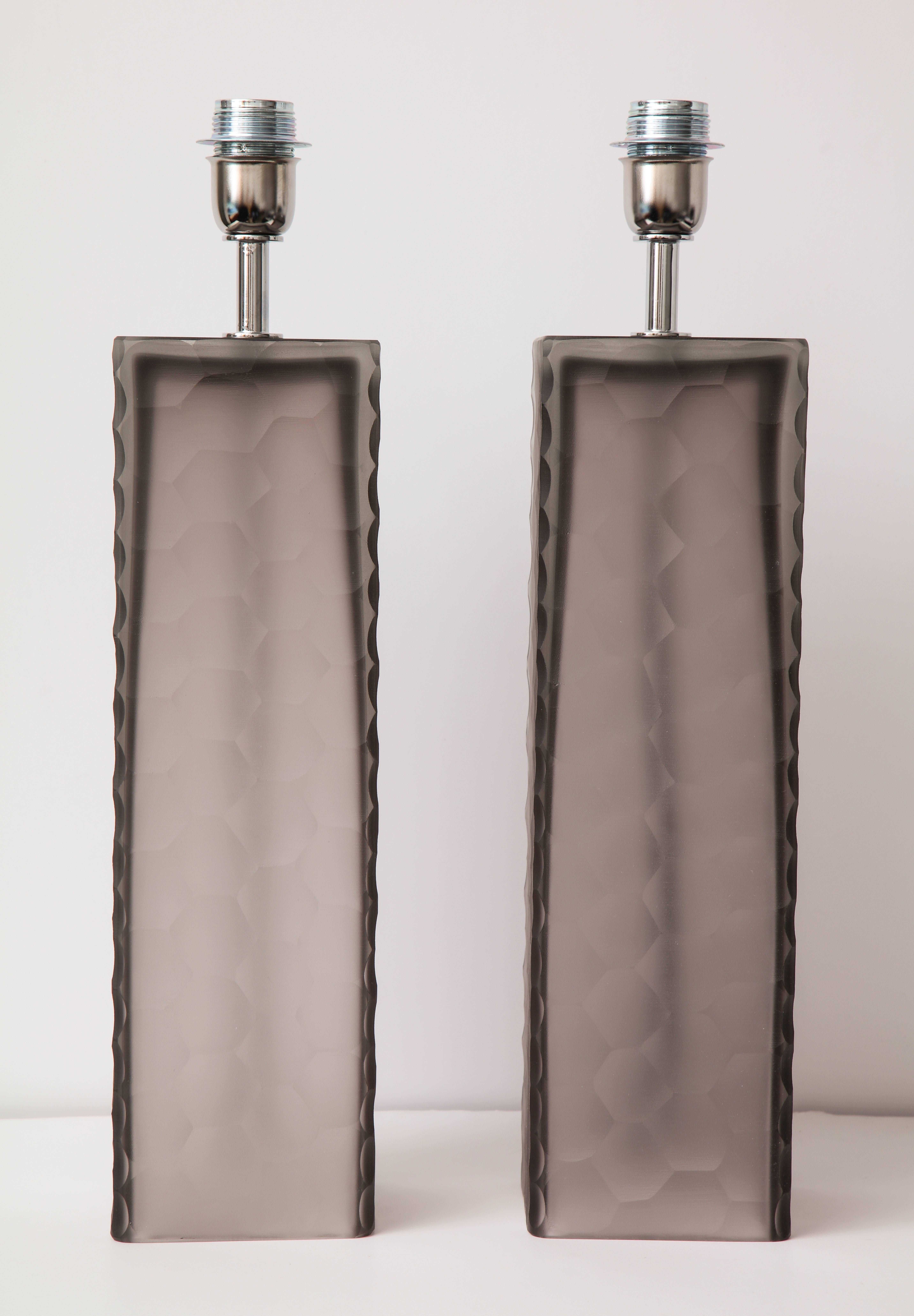 This pair of taupe grey or gray Murano glass lamps was made of hand casted blocks of Murano glass with a beehive-like stamped design texture. Signed by the Murano glass master, Alberto Dona. Wired for U.S. use.  These lamps will come with a uno