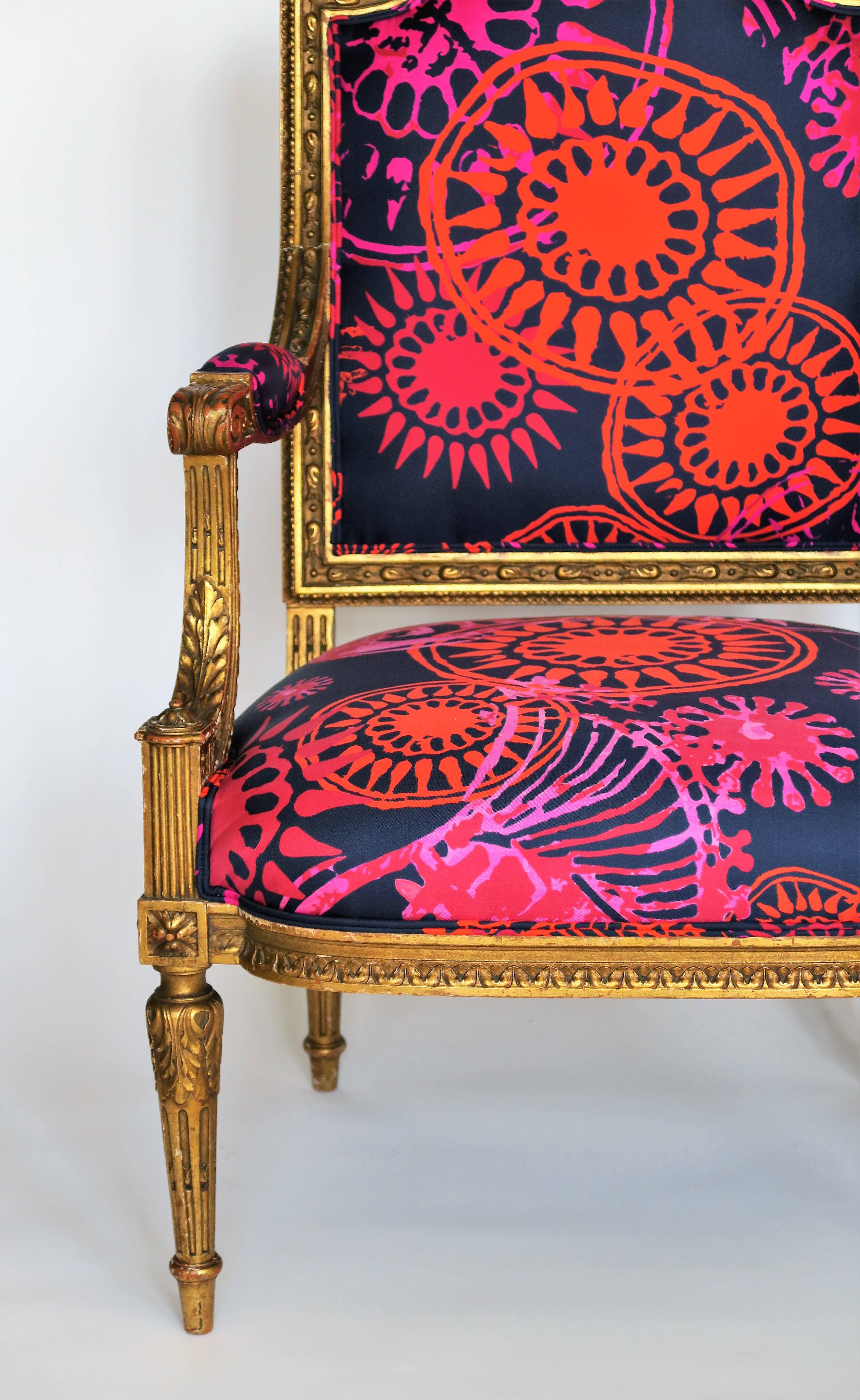 Breathtaking restoration of one gilded (gold) and hand-carved, late 19th century Louis XVI style armchair. The frame is original and shows beautiful gilded patina with chips and scratches commensurate with the chair's age and use. Stunning details.