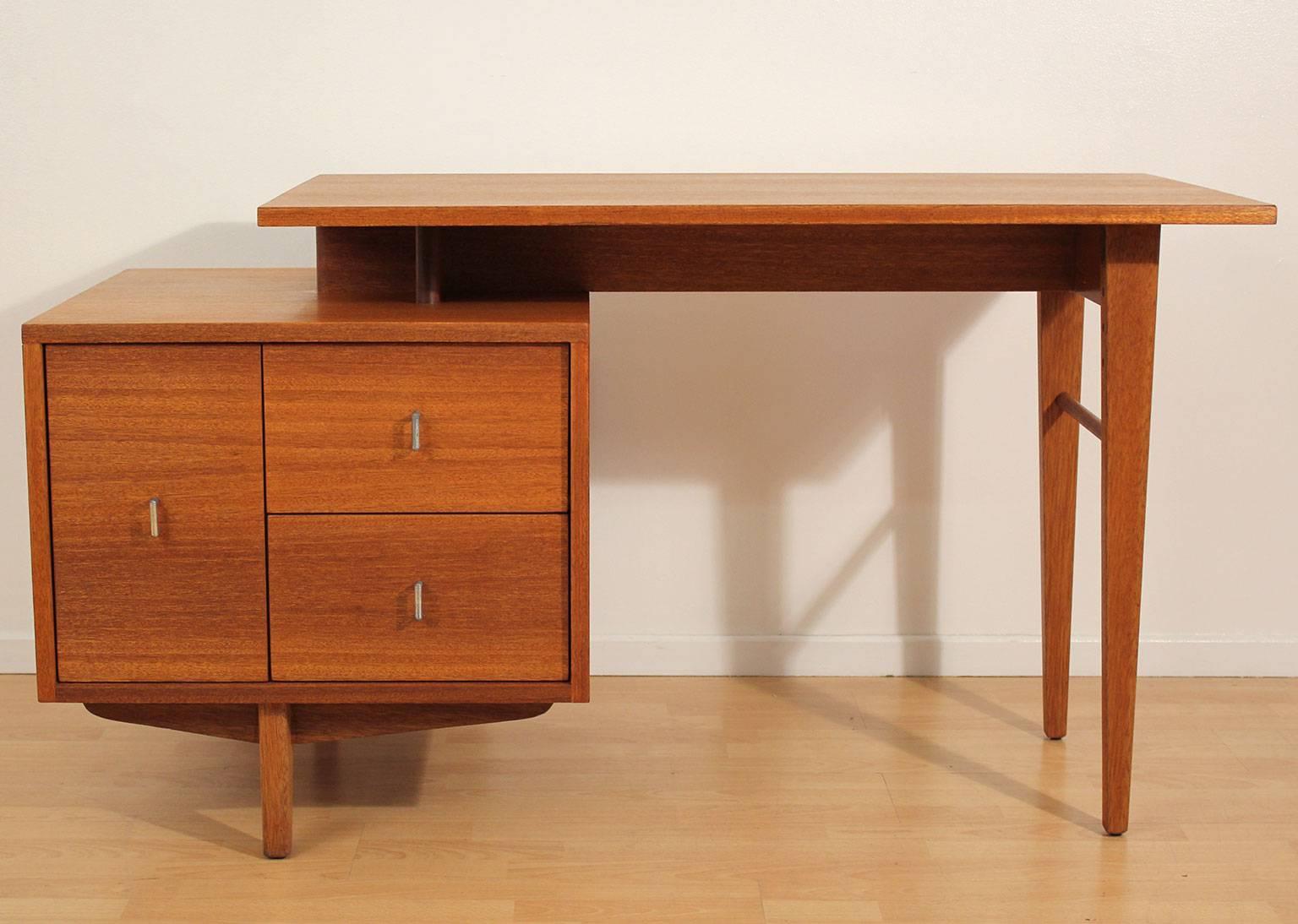 Early Brown Saltman desk designed by John Keal, circa 1950s. Made of beautiful mahogany wood. Has an opening in the front for books and makes this desk great floating. Awesome design. Wood is completely restored to original condition. Total length