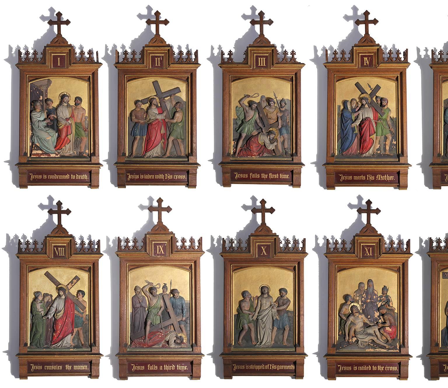 Stunning set of fourteen Gothic Revival Stations of the Cross hand-painted plaster tile paintings incased in beautiful hand-carved elaborate wood frames. Each has wonderful detail and numbered in a Roman numeral. Titles are in English. The stations