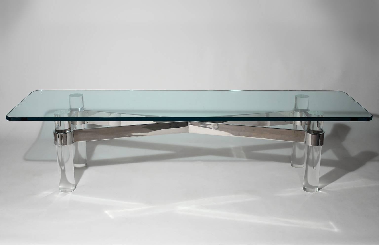 Long glass top coffee or cocktail table with chrome steel and Lucite base. In the manner of Karl Springer, circa 1970s.