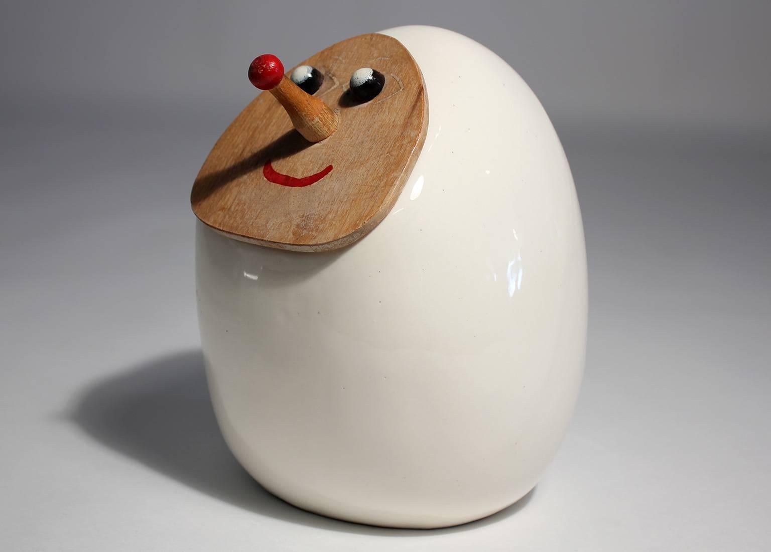 Whimsical ceramic cookie jar with painted wood face lid designed by Lagardo Tackett.