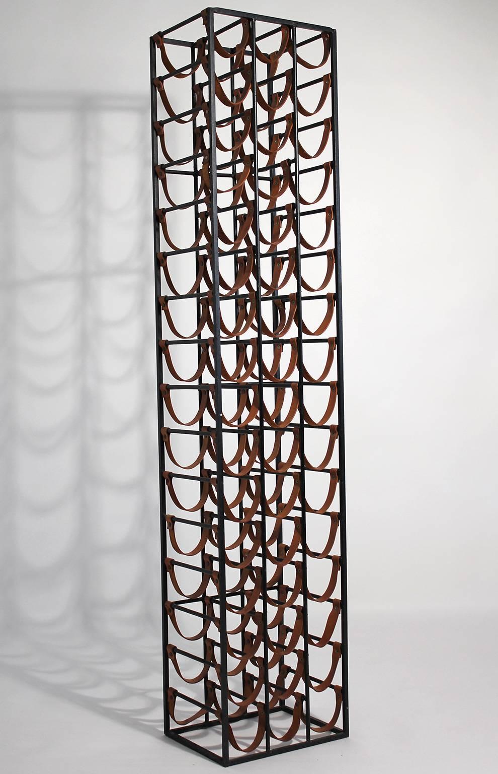 Vintage Mid-Century wrought iron and leather 48 bottle wine rack designed by Arthur Umanoff. Over five feet tall. Original.