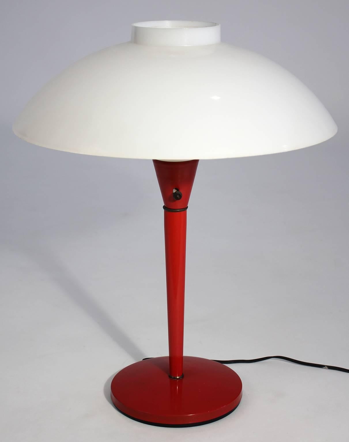 Original Gerald Thurston for Lightolier desk/table lamp dating from the 1950s. Has the original glass inner globe and plastic shade. Original red enable paint is in very nice condition with light normal wear from age. No cracks to the glass or