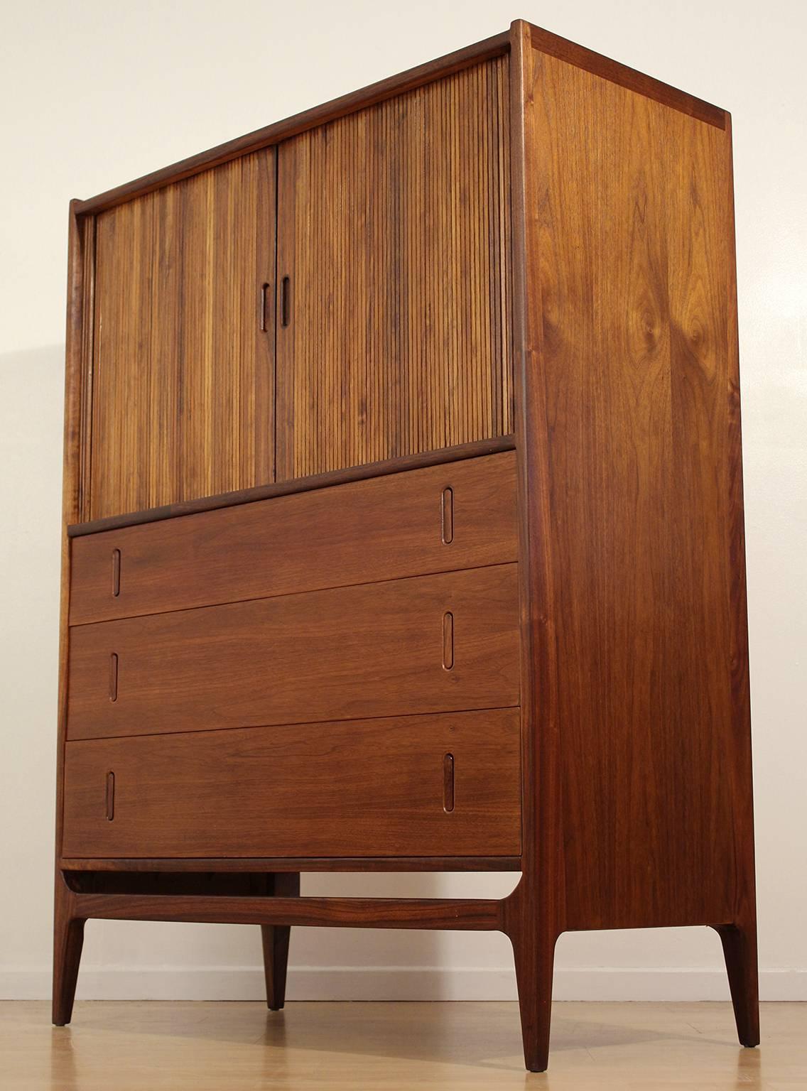 Glenn of California dresser or gentleman's chest designed by Richard Thompson. Top features tabor doors and a beautiful modernist design. Made of stunning walnut with rosewood pulls. Excellent vintage condition.