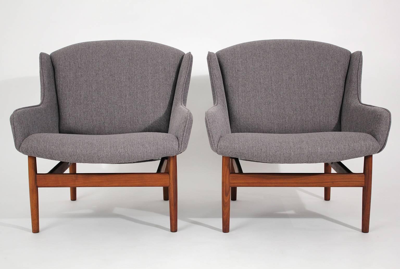 Completely restored Jens Risom designed lounge chairs for Jens Risom Design, Inc. circa 1950s. Pair of chairs have a great modernist design and form. These chairs sit well and are very comfortable. Walnut frames have been restored and thy have new