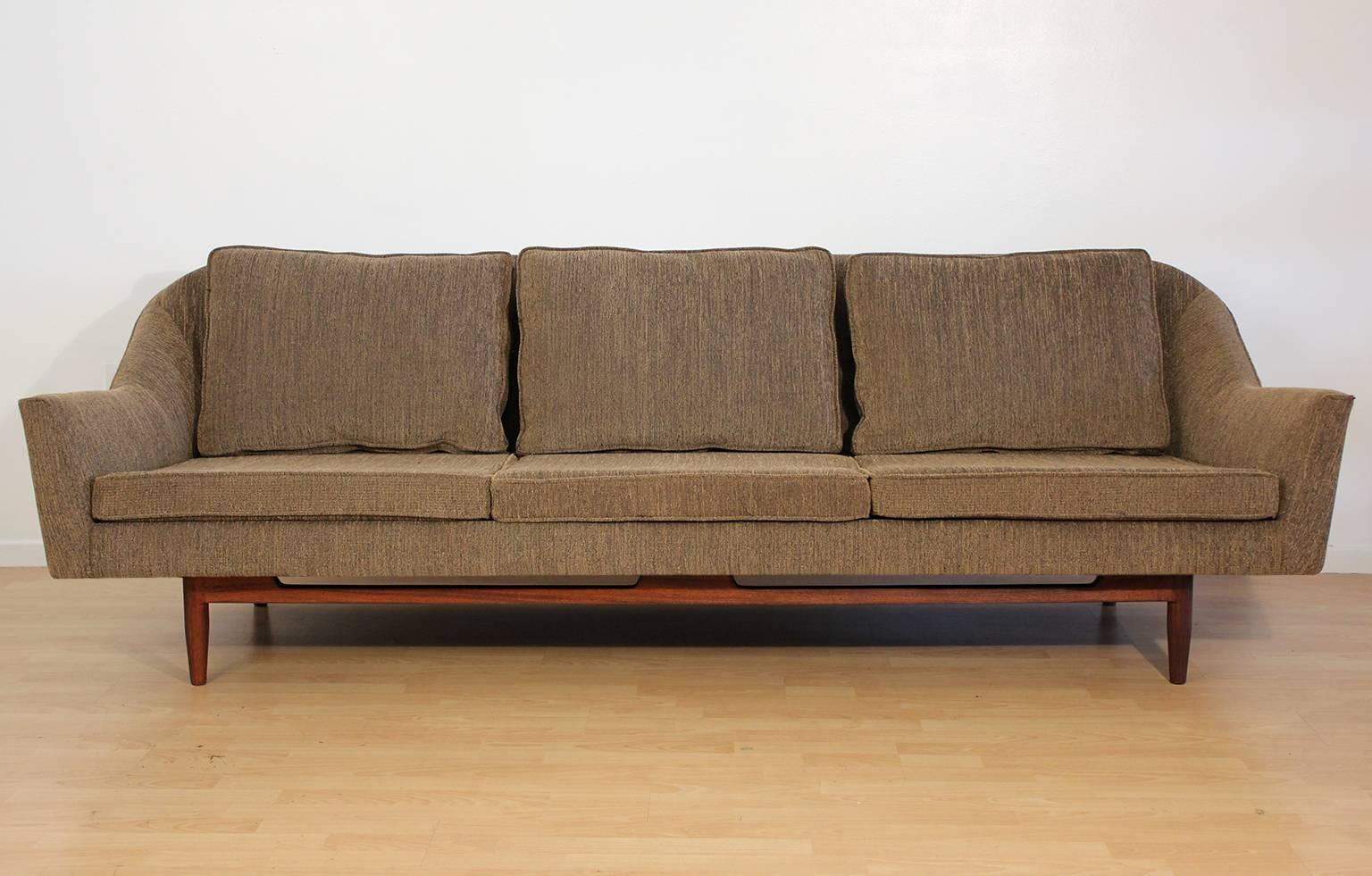 Completely restored Jens Risom designed sofa for Jens Risom, Inc. circa 1950s. Great design and form. Walnut base has been restored and sofa has new upholstery and foam. New back down cushions. Very comfortable sofa.