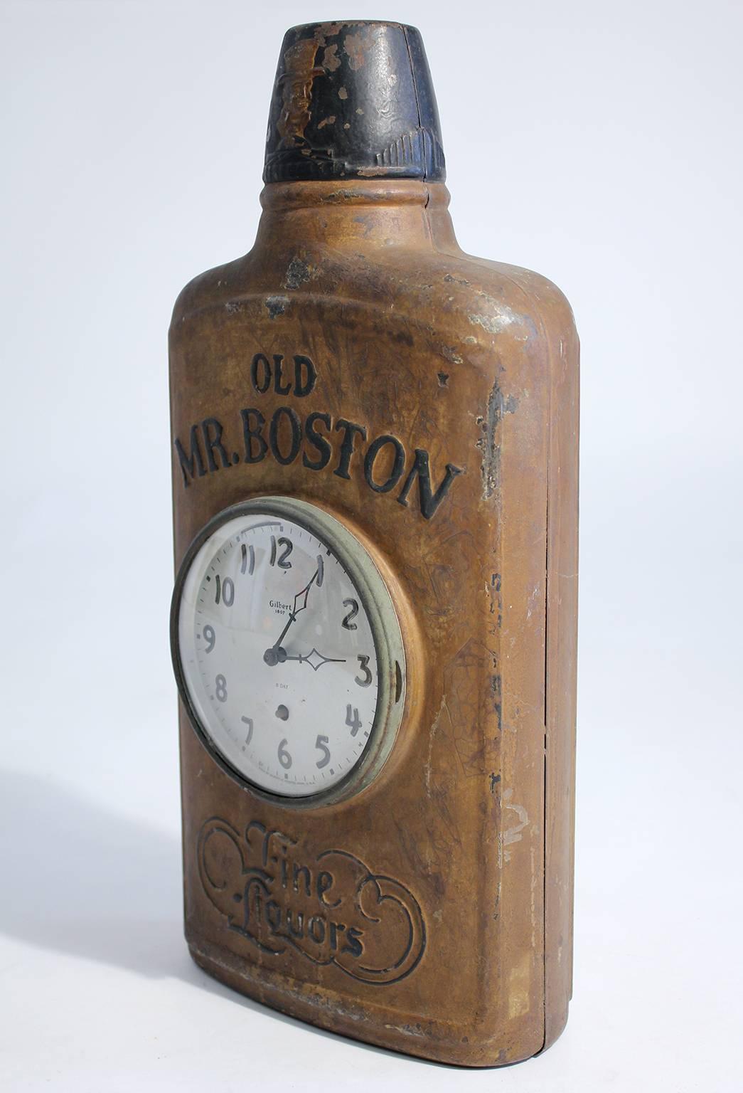 Antique Mr. Boston Fin Liquors advertising clock trade sign. In the shape of a flask and dates from the 1930s. Great decoration for a bar. Made of metal and has the original finish. Works.