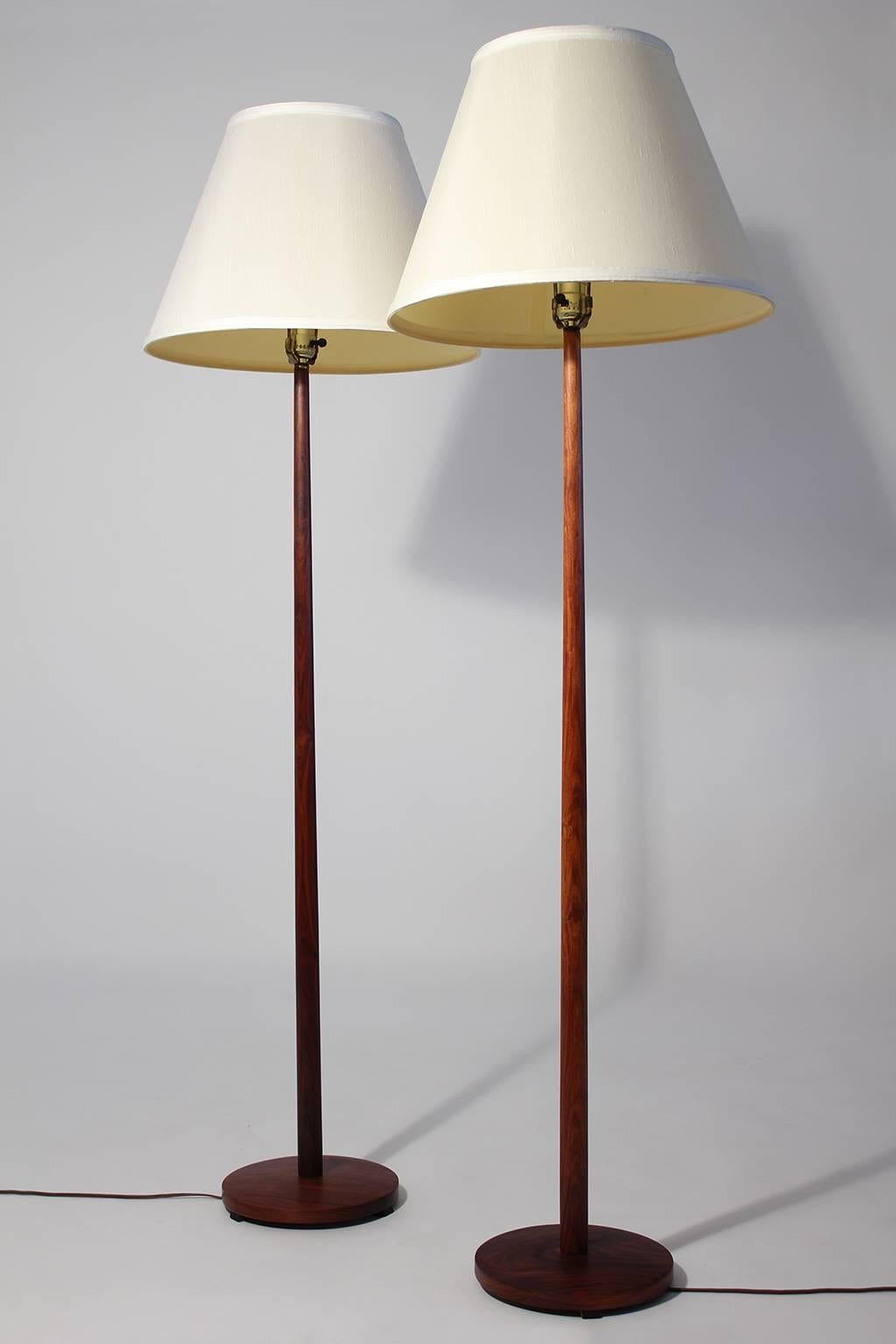 Pair of vintage modernist rosewood floor lamps with weighted bases made in Sweden, circa 1960s. Overall height of 58.5