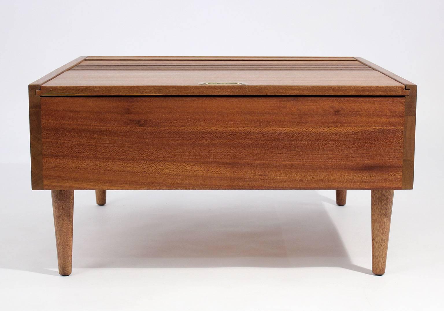 Early Brown Saltman coffee table designed by John Keal, circa 1950s. The coffee table is made of beautiful mahogany wood. Top has a tambour door that opens up for storage. Has been restored to the original condition.