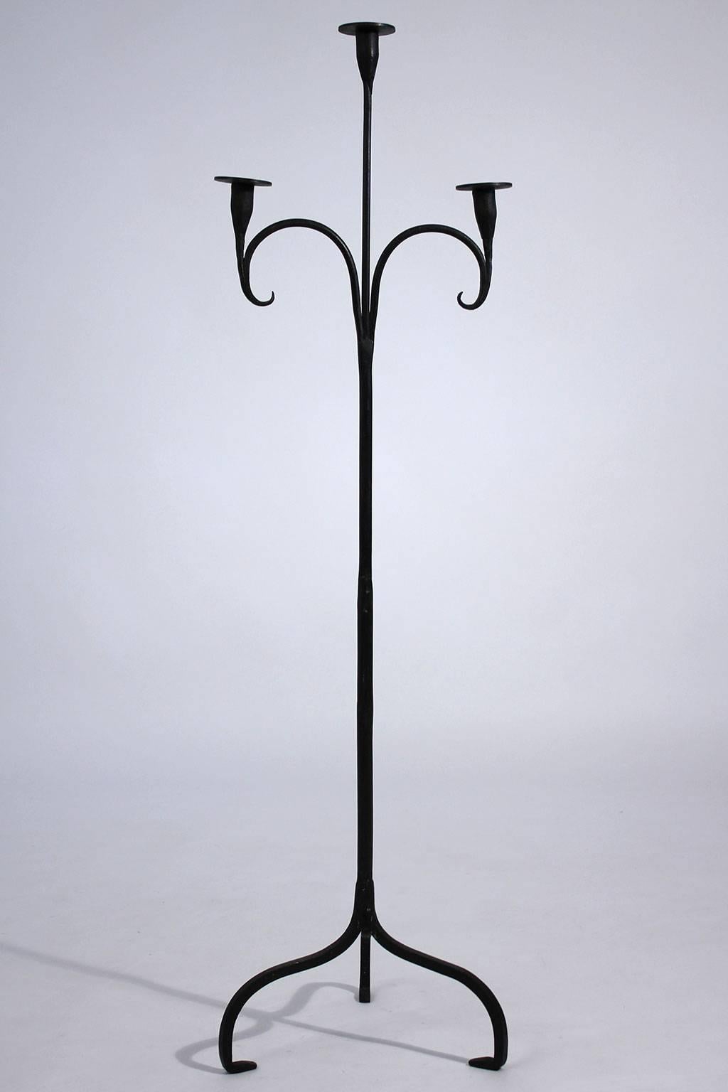 Hand-forged early California Rancho Monterey period wrought iron standing three candle candelabra. Condition is excellent and has a wonderful design. Has original painted surface.