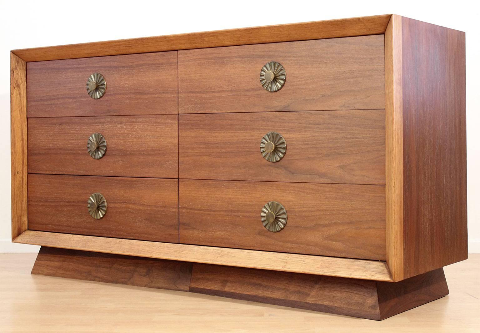 Beautiful modernist design six-drawer dresser. Made of walnut wood with wonderful brass hardware. Great patina on the hardware and can be polished if desired. Great design and has been completely restored. Wood has beautiful color and grain.