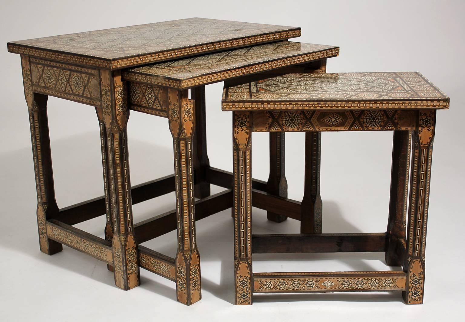 Beautiful set of three Moorsih marquetry inlay nesting tables. In very nice original condition with normal wear consistent from age. The tables are made of solid wood and inlay design is beautiful. 

Table measurements are:
Large: 21.25