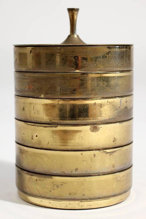 Rare set of brass drink coasters by Tommi Parzinger for Dorlyn, 1950s. The set consists of six stacking coasters with a decorative lid. All pieces are stamped 