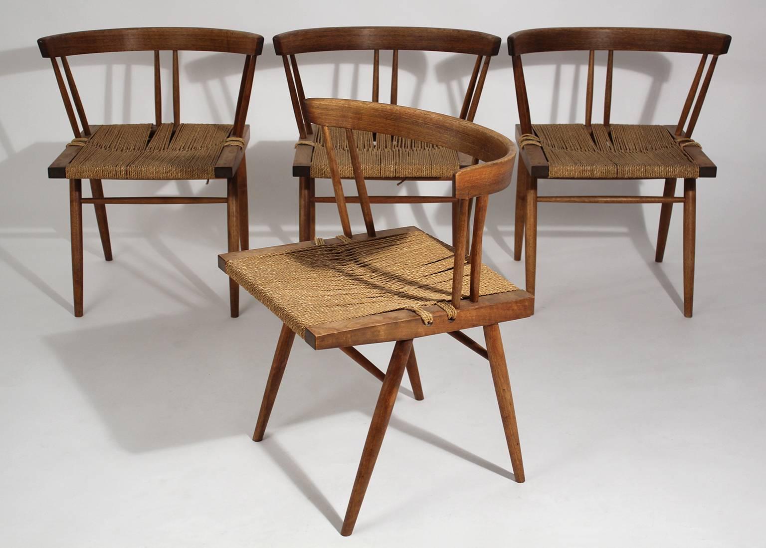 Beautiful set of four original George Nakashima grass seat walnut chairs, dating from 1950. These chairs are 100% original and unrestored. They are in very nice original condition. Very sturdy. Comes with original paperwork from George Nakashima,