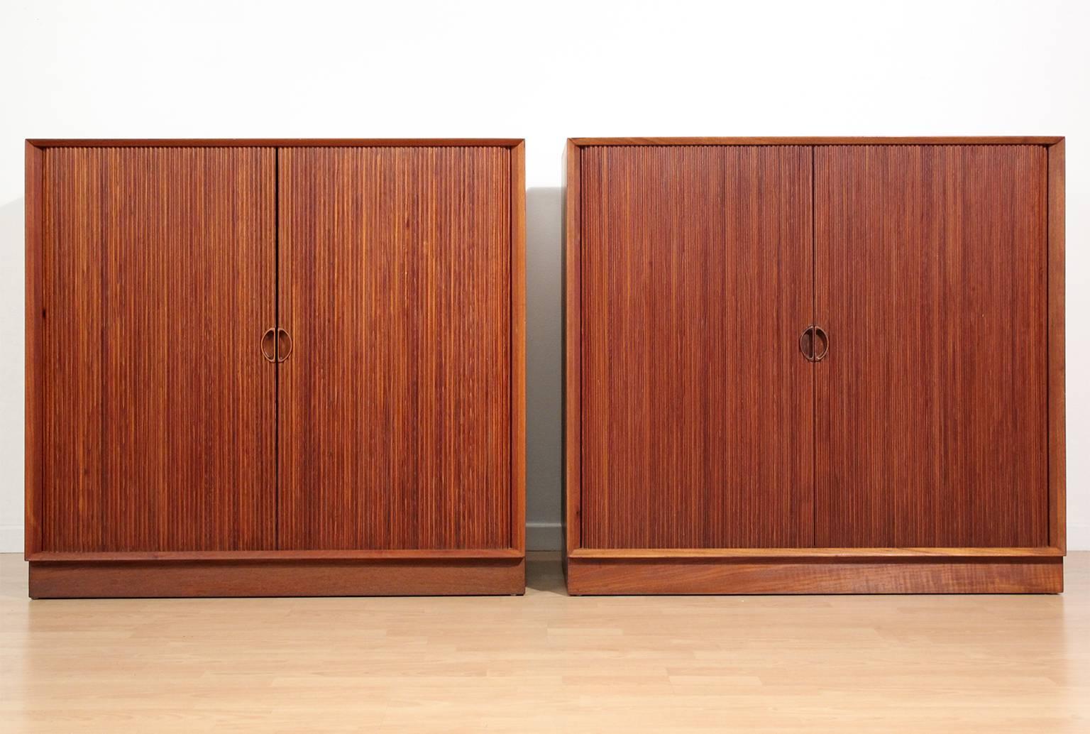 Great pair of Danish teak tambour chests or buffets by Peter Hvidt & Orla Mølgaard Nielsen. Chests feature two interior adjustable shelves. Doors open and close as they should. In excellent condition with no issues. These have been hand oiled and