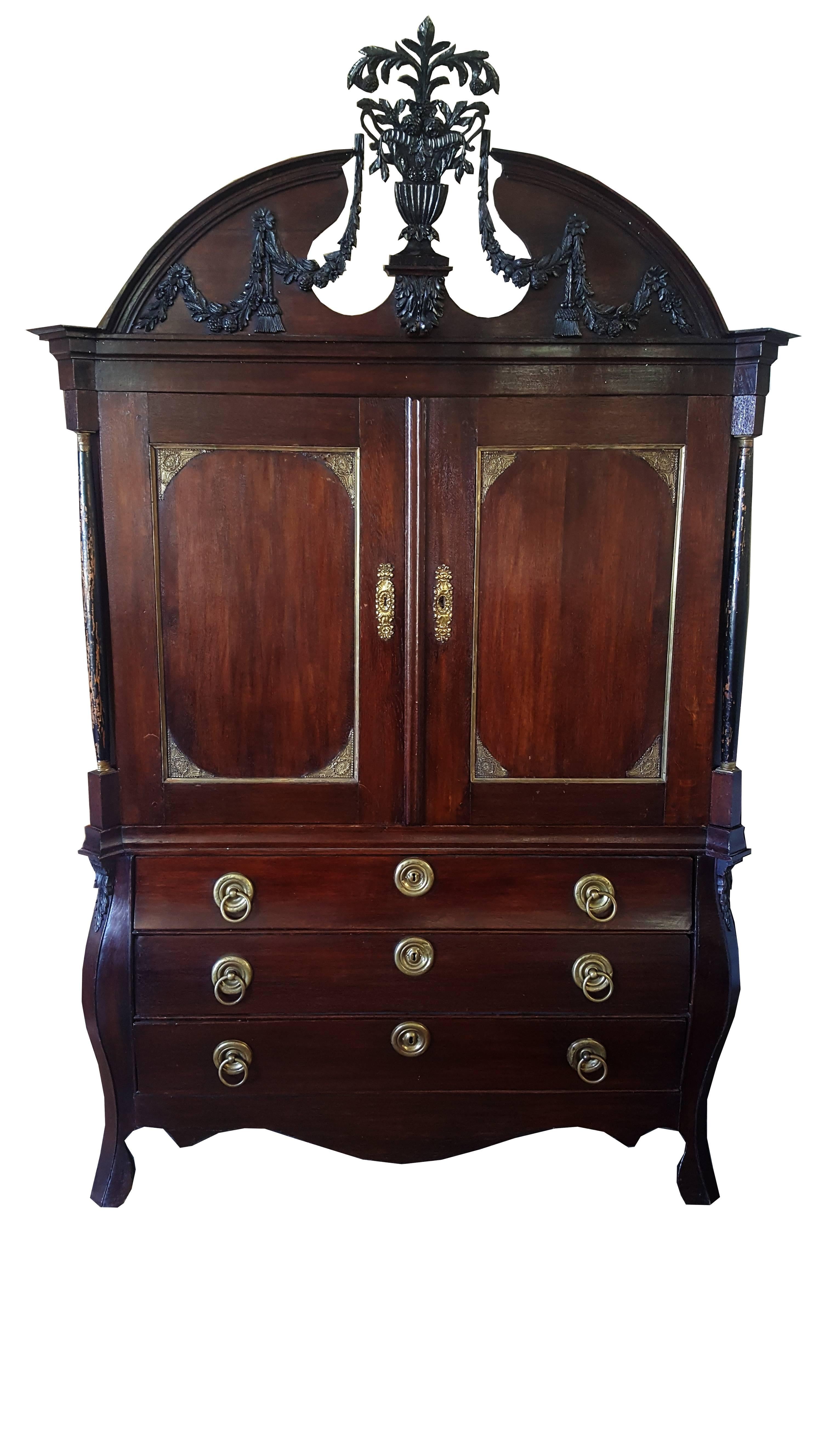 Almost identical pair of 19th century Dutch Colonial linen presses. Stunning hand-carved details and delicate gilt work adorn this delightful pair of mahogany linen presses. Elegant brass hardware finishes puts the cherry on top of this gorgeous
