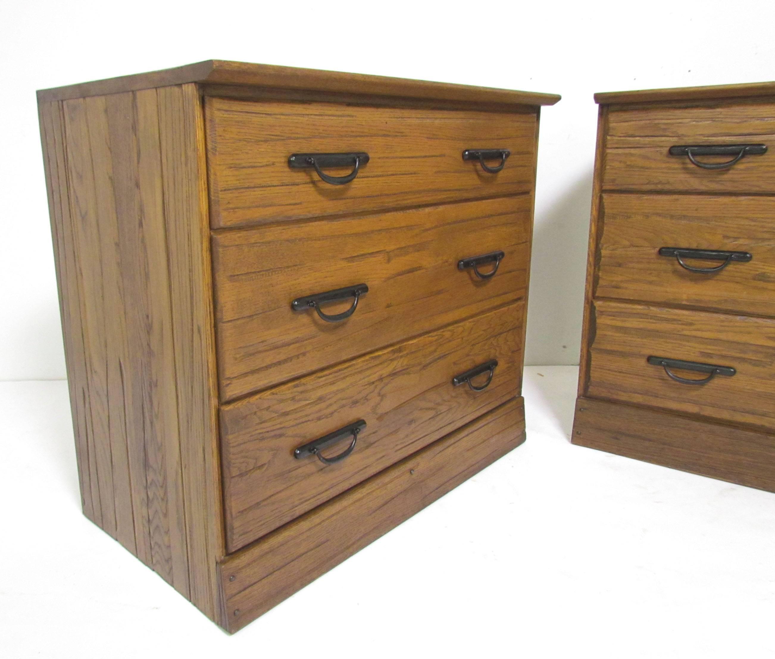 Pair of rustic, almost tansu style Ranch Oak three-drawer chests with cast iron handles by A. Brandt Furniture Co., circa 1960s.