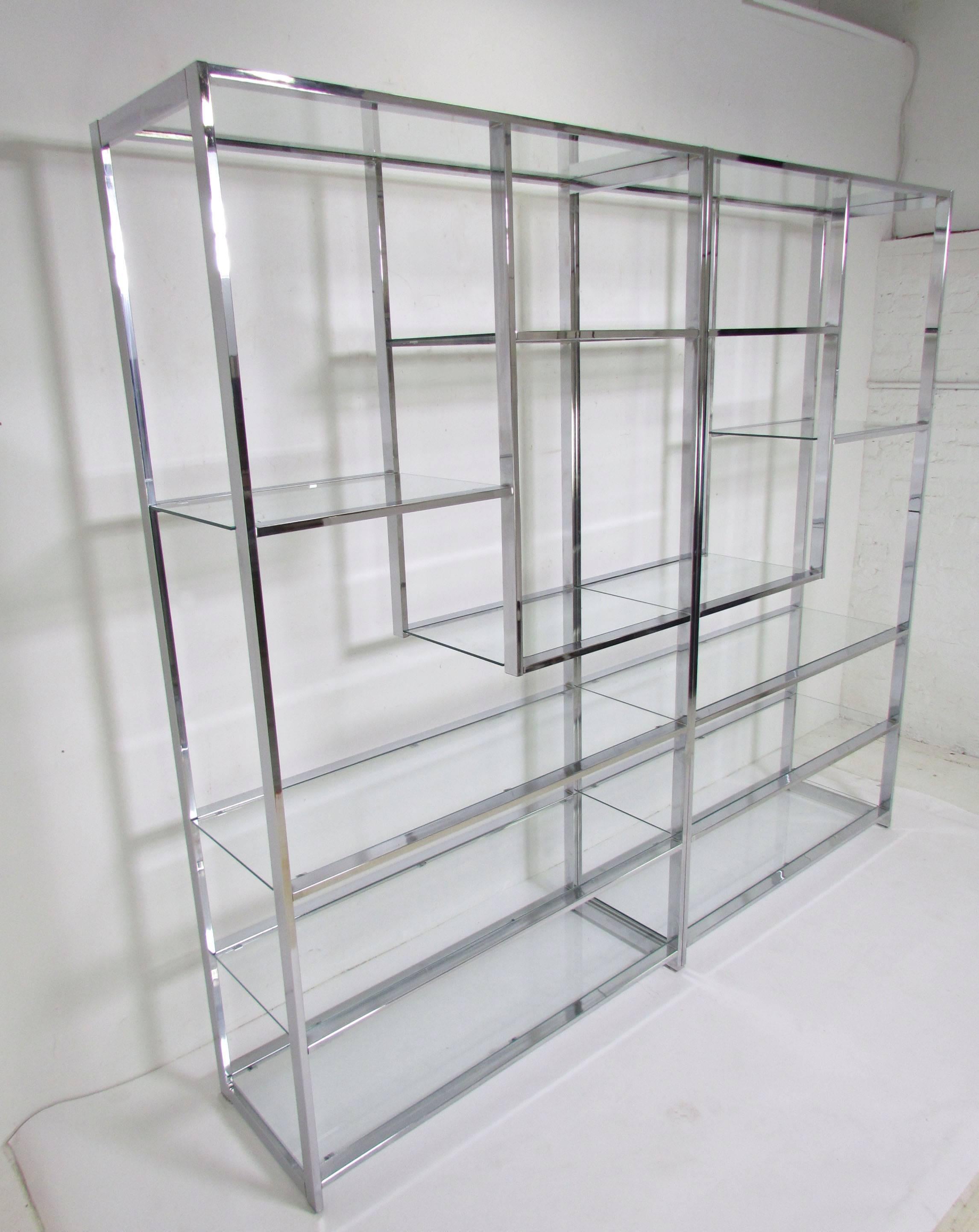 Pair of etageres in chromed steel with glass shelves by Milo Baughman for Design Institute America (DIA), circa 1970s. Can be used together as shown, or separately if preferred. 

Each one measures 42