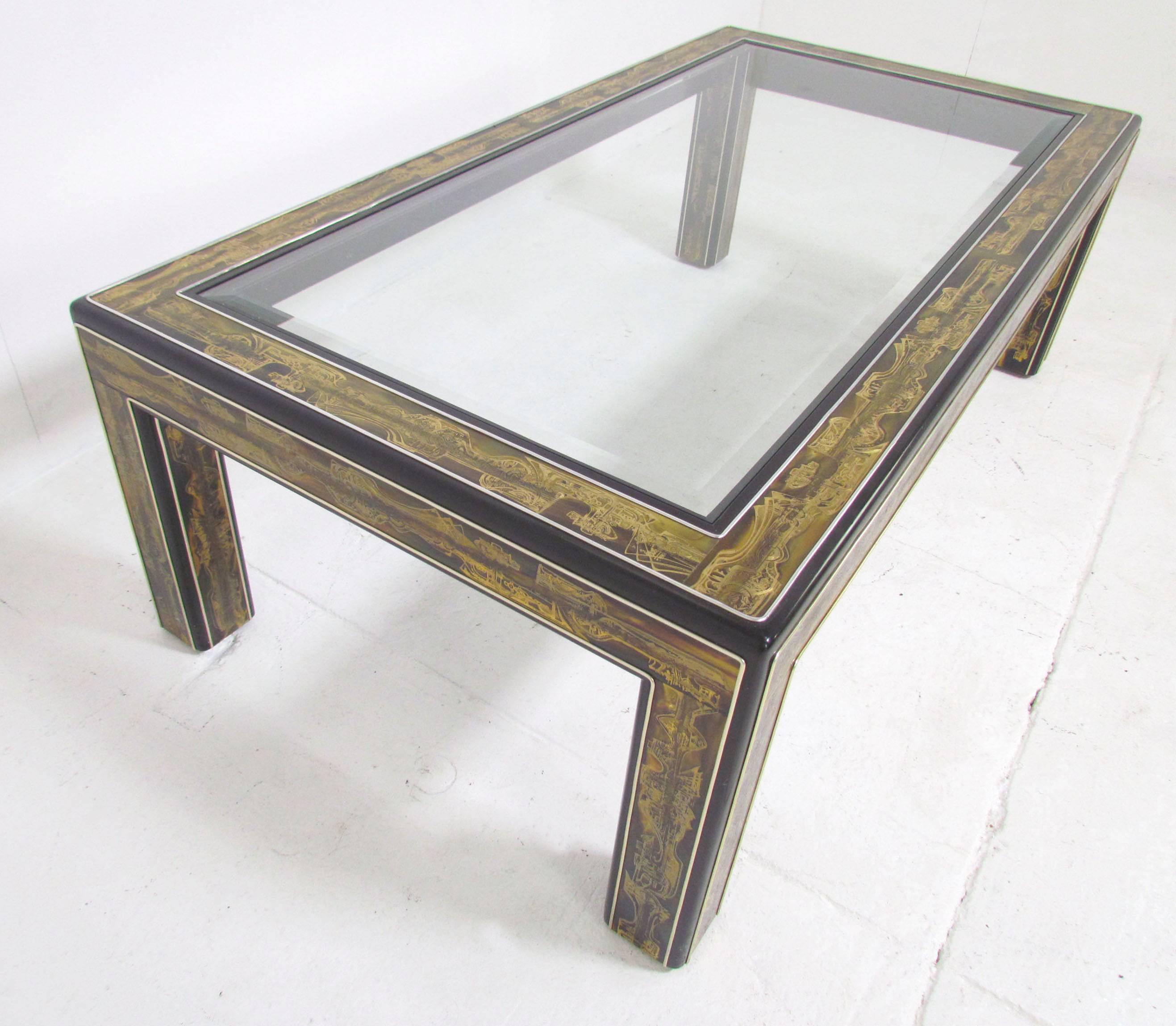 Parsons style coffee table by Bernhard Rohne for Mastercraft with abstract acid etched decoration on brass panels, affixed to a lacquered wood frame. The glass is lightly smoked.