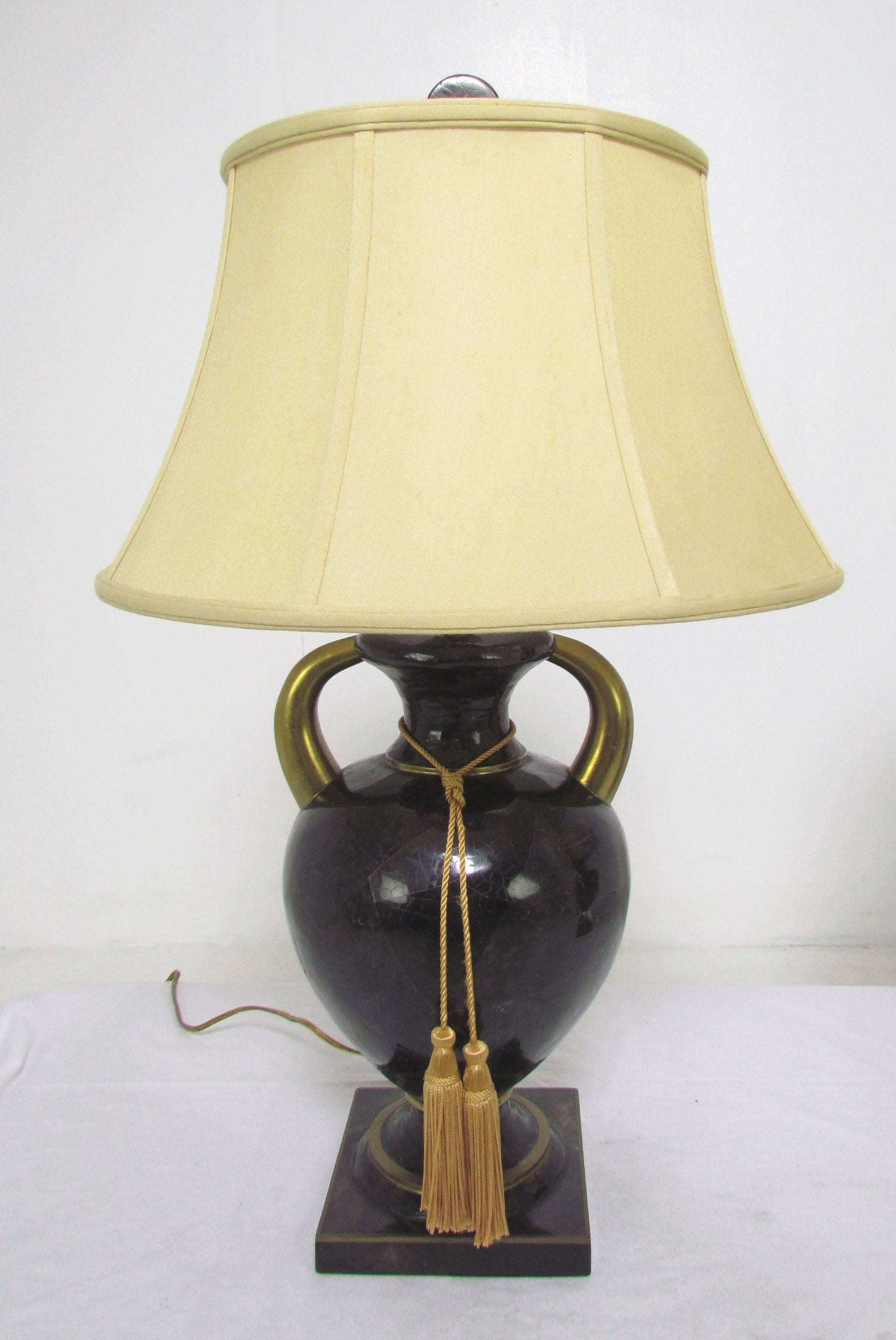 Pair of urn form table lamps in tessellated horn, with brass accents, by Maitland-Smith.

Measures: 28" high to top of finial, 8" diameter. Shades 17.5" diameter, 9.75" high.
