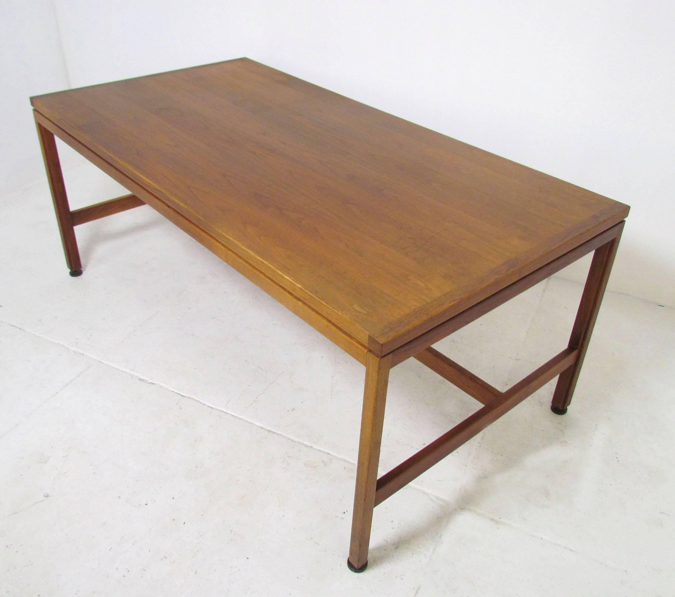 Spacious Mid-Century architect's desk in walnut with sleek modernist lines by Jens Risom, circa 1960s. Retains all original adjustable bronze glides. 28.75" high as shown.