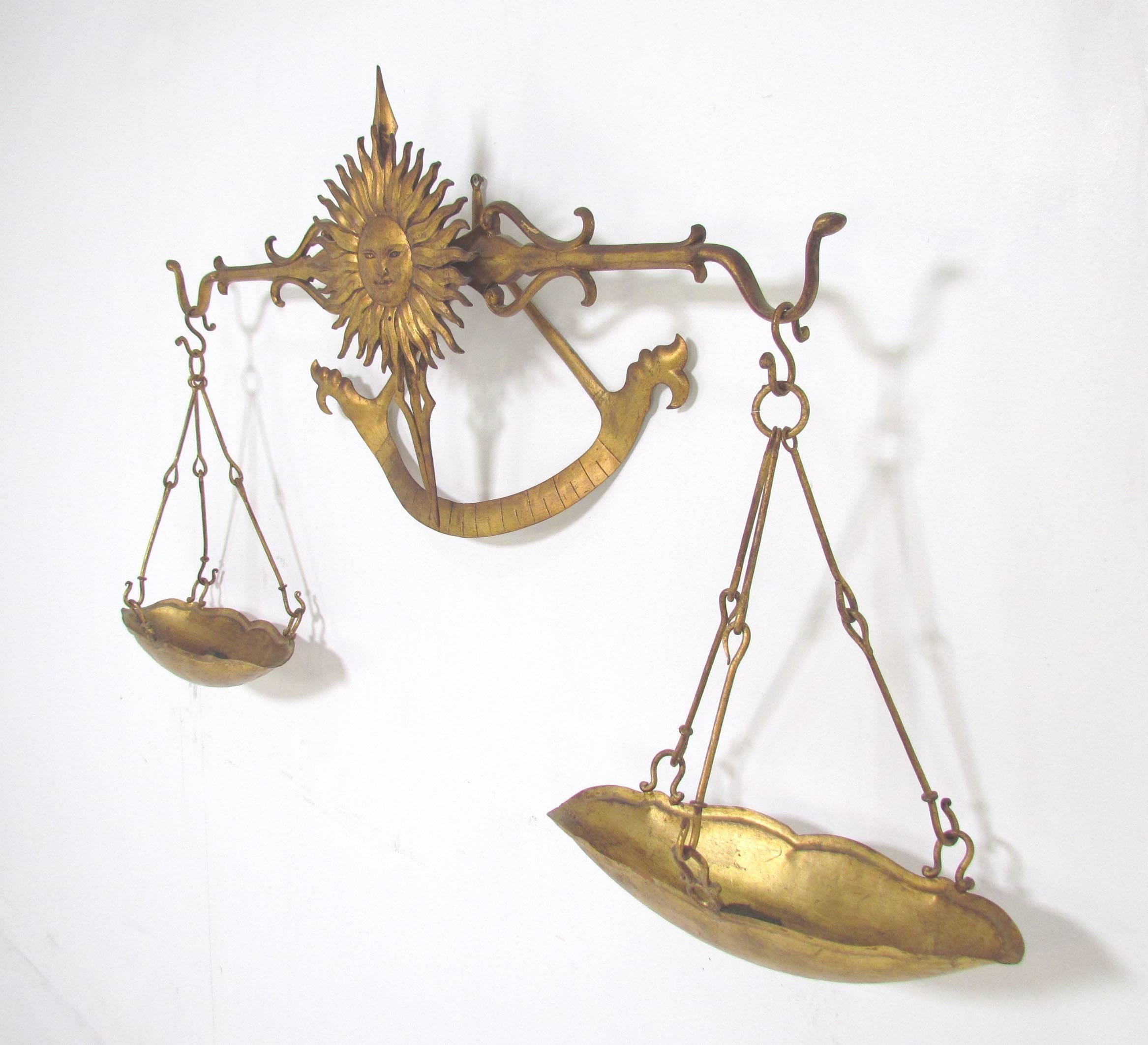 Unusual decorative gilt metal wall-mounted scale with sun motif by Palladio, Italy, better known for their mirrors. Previously used as a planter, the weighing pans could also serve as vessels for a variety of small items from colored glass to candy.