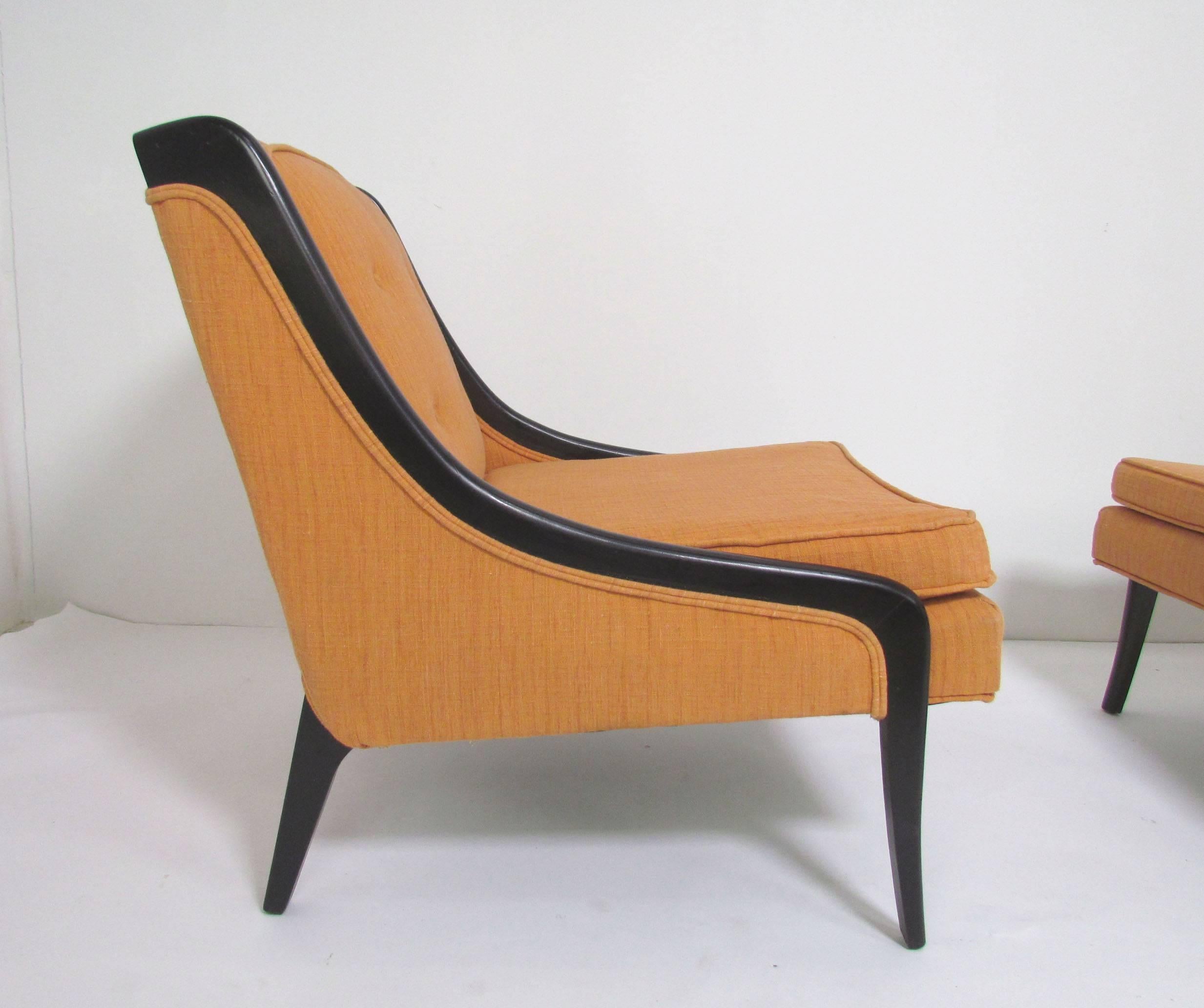 Pair of Mid-Century lounge chairs with lacquered ebonized frames, curves reminiscent of designs by Harvey Probber. 

    