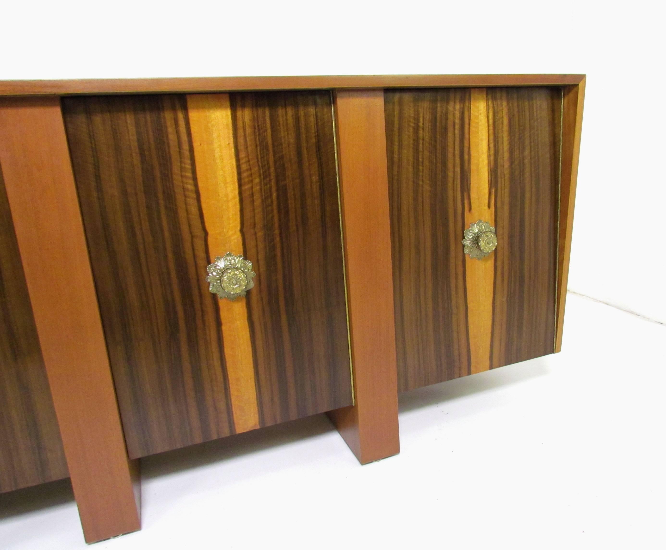 Stunning custom-made seven and a half-foot long sideboard with zebrawood doors and Honduran mahogany case, by Adolfo Genovese for F & G Handmade Furniture Co, circa late 1950s. Middle sections feature drawers for flatware and other storage, while