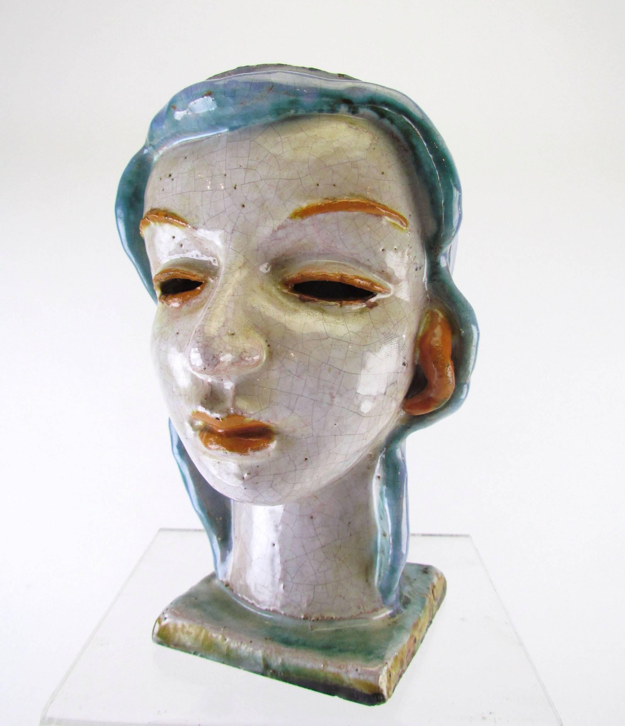 Wonderful sculpture of a head of a woman, in hand glazed and molded terracotta, marked "Made in Austria", in the manner of Wiener Werkstatte or Goldscheider.