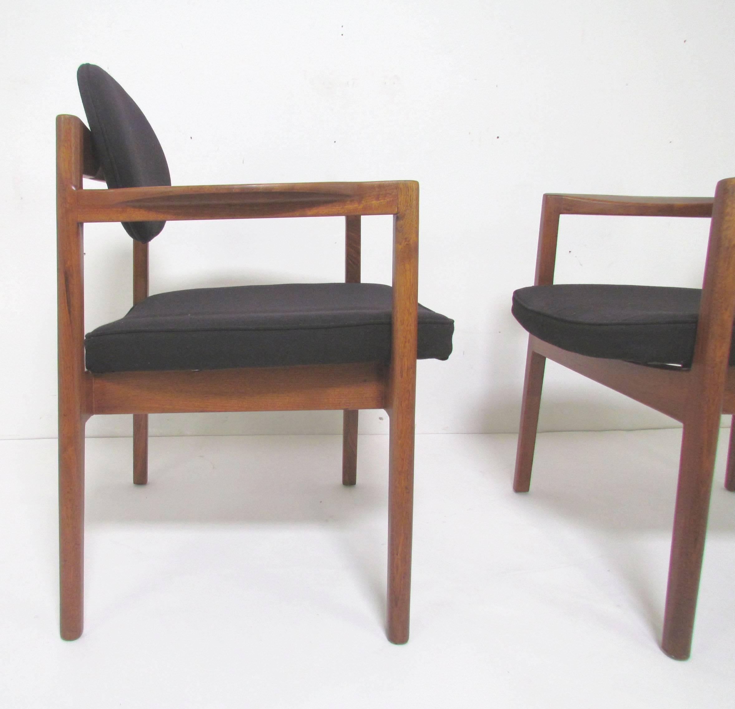 Pair of armchairs in solid walnut, circa 1960s. This model is often attributed as the work of Jens Risom. Note, we have a second pair available in the same original upholstery, sold separately. All four were used by the prior owner as dining chairs