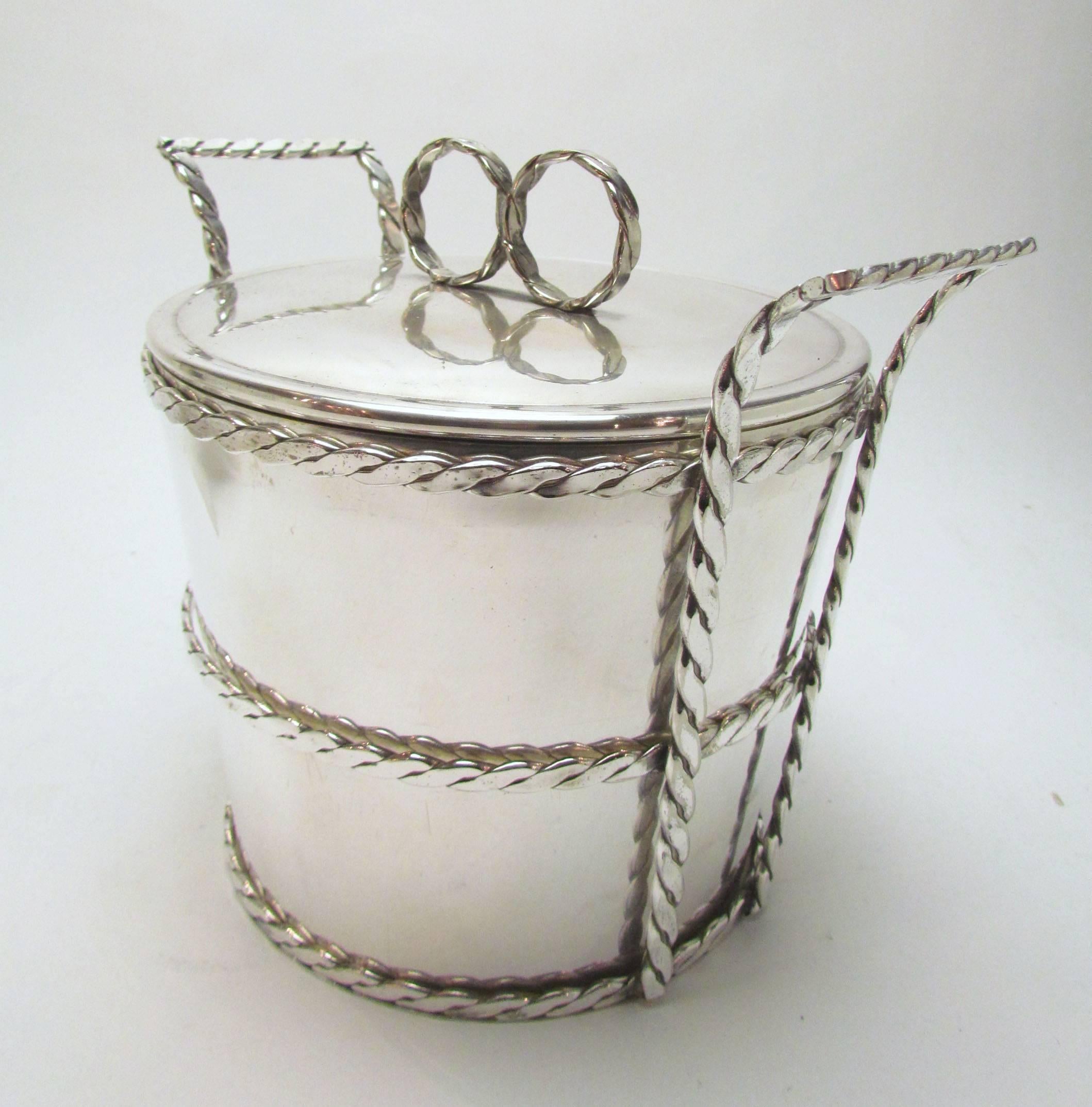 Silver plate ice bucket by Cartier, stamped on bottom, and made in Italy. Interior insulated bowl is removable so that bucket can be used to chill a bottle of sparkling wine.