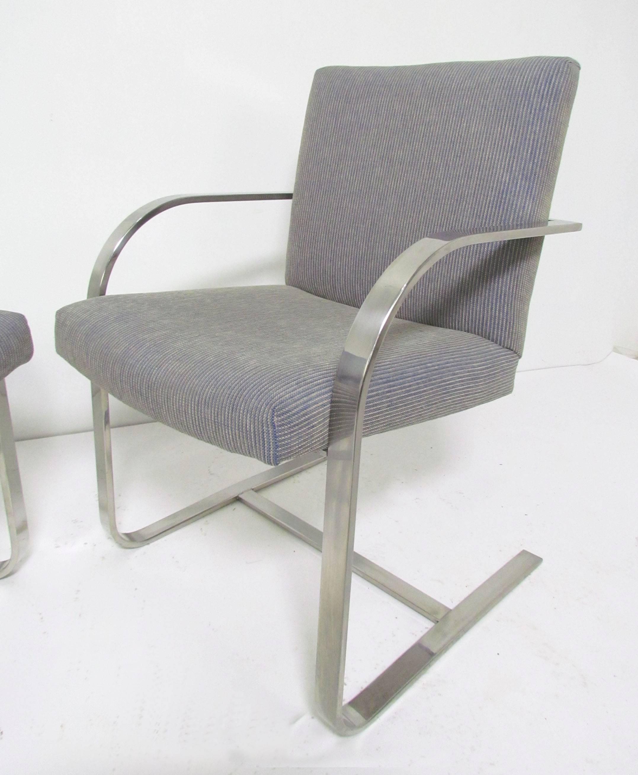 Set of four flat bar chrome cantilever chairs, in the style of Mies van der Rohe's iconic Brno chairs. This set with chrome back bar, attributed to Brueton, circa 1970s.

Please see our other listings for another set of four in same upholstery